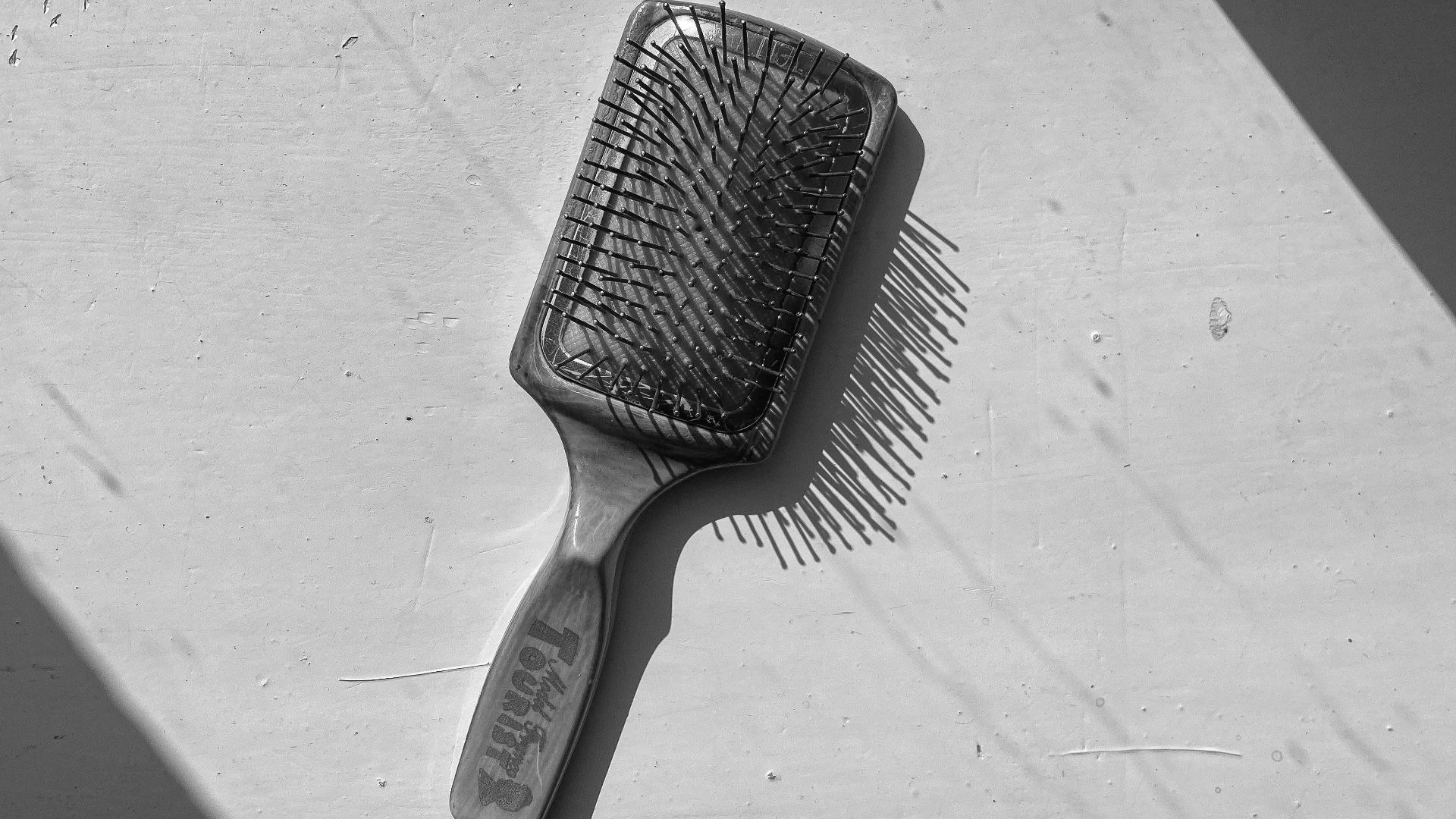 a black and white photo of a hair brush