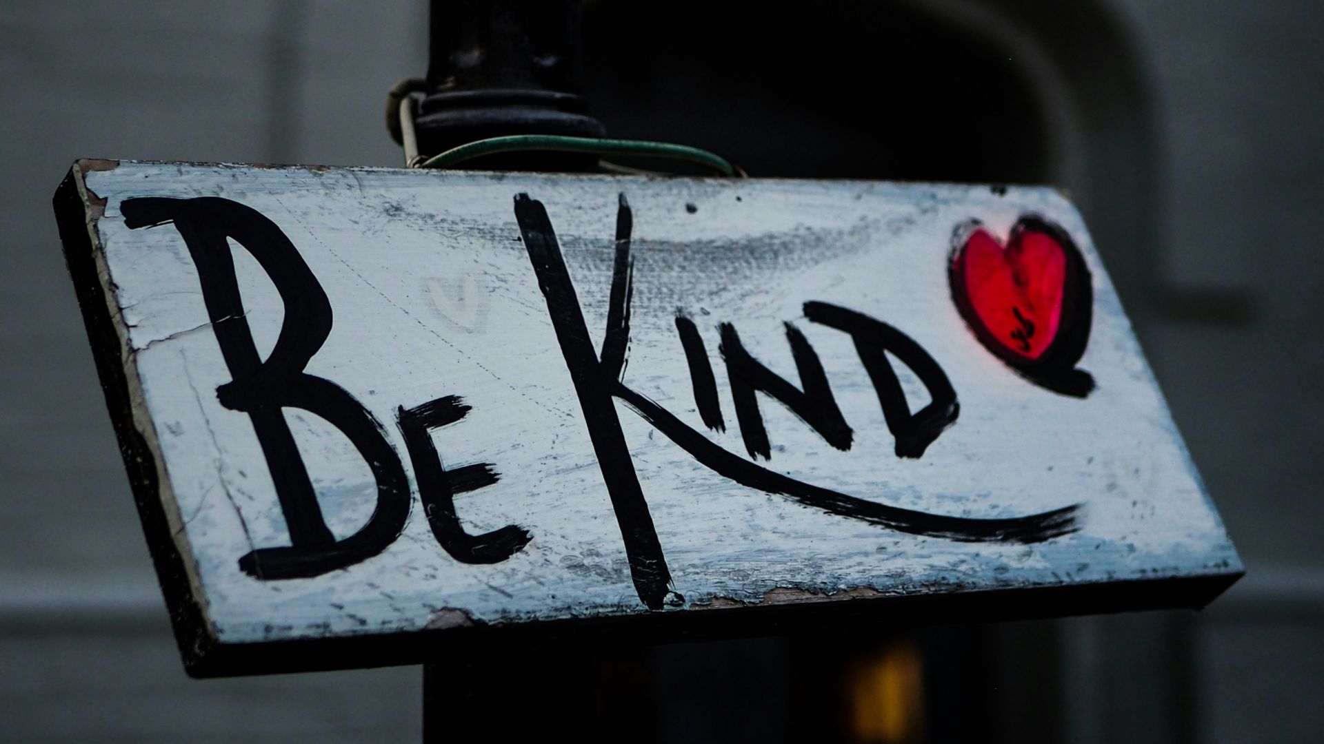 a sign that says be kind on it
