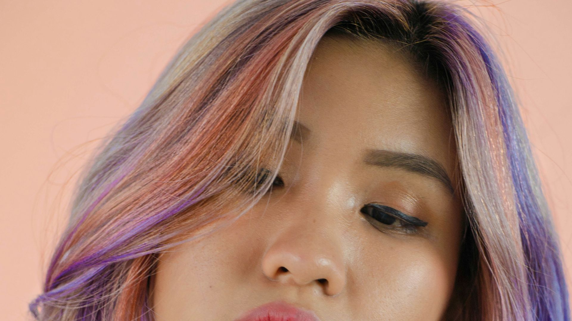 a woman with purple hair and a checkered shirt