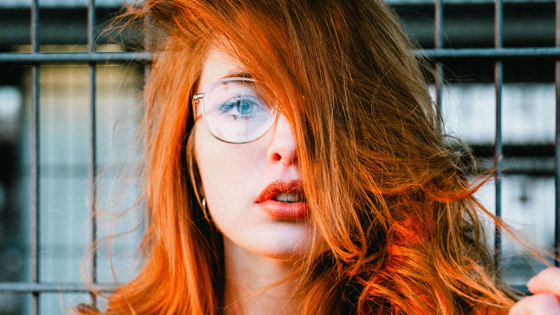 selective focus photo of woman wearing eyeglasses with orange hair