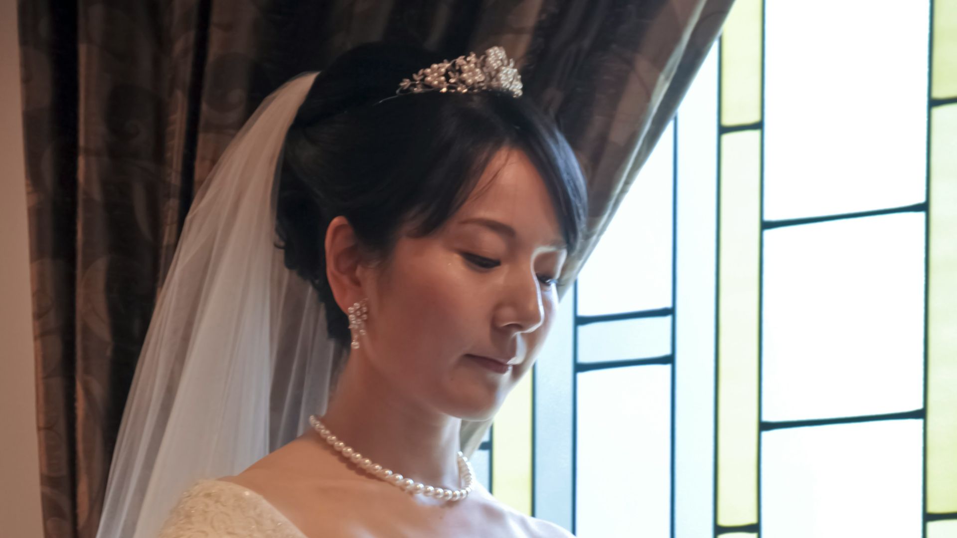 a woman in a wedding dress holding a bouquet of flowers