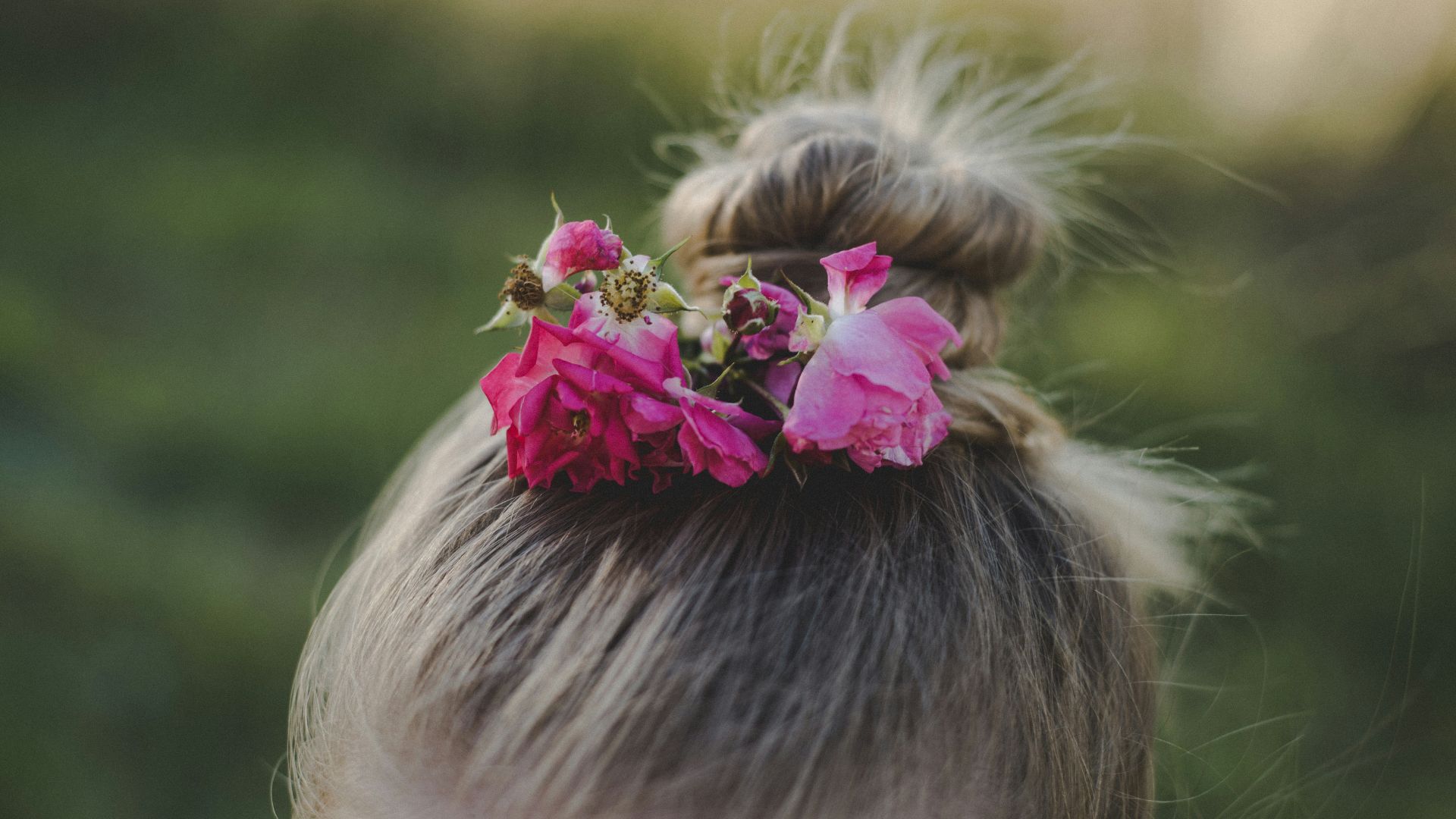 close-up photo of girl with flower bun on hair