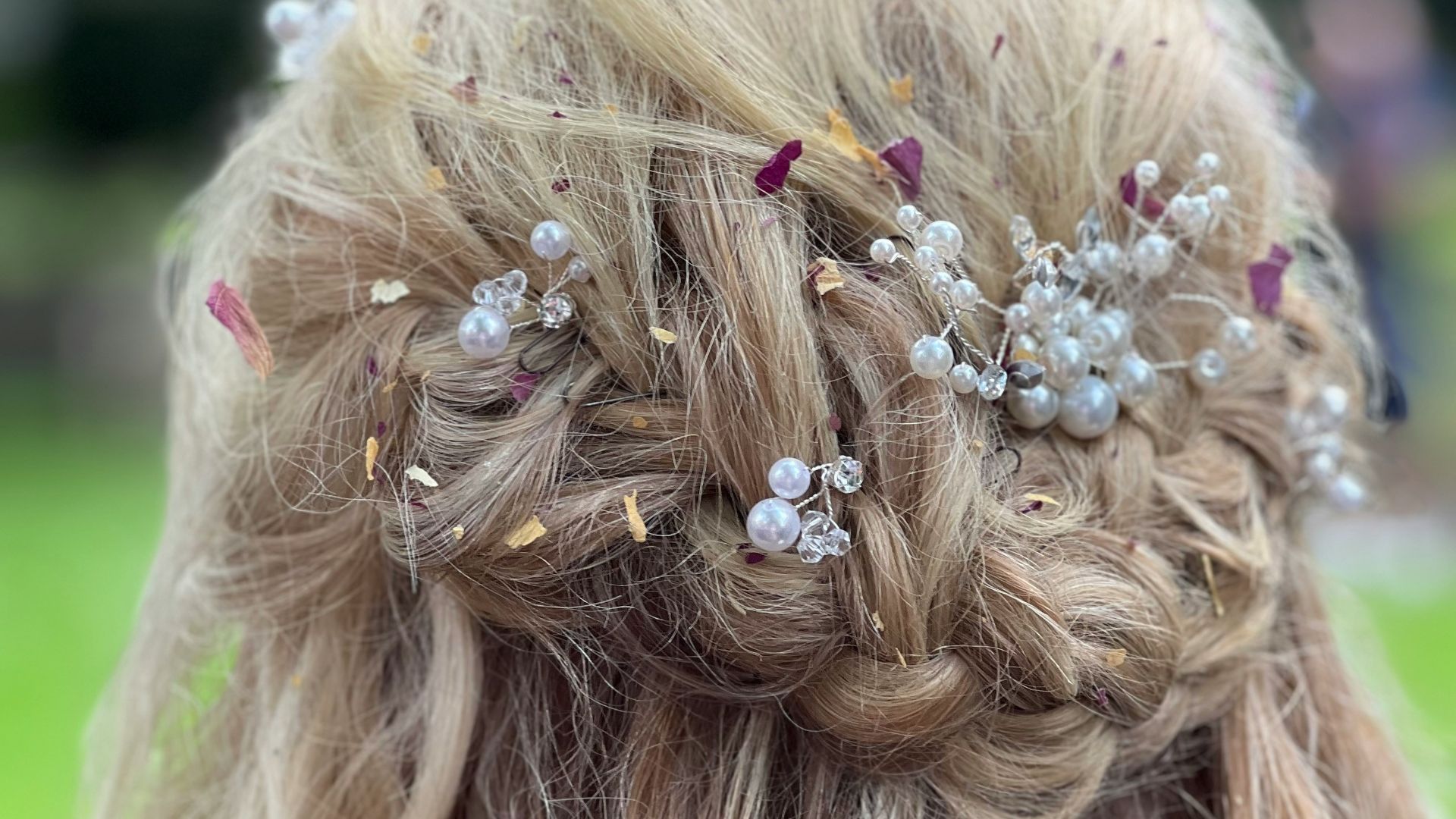 a close up of a woman's hair with flowers in it
