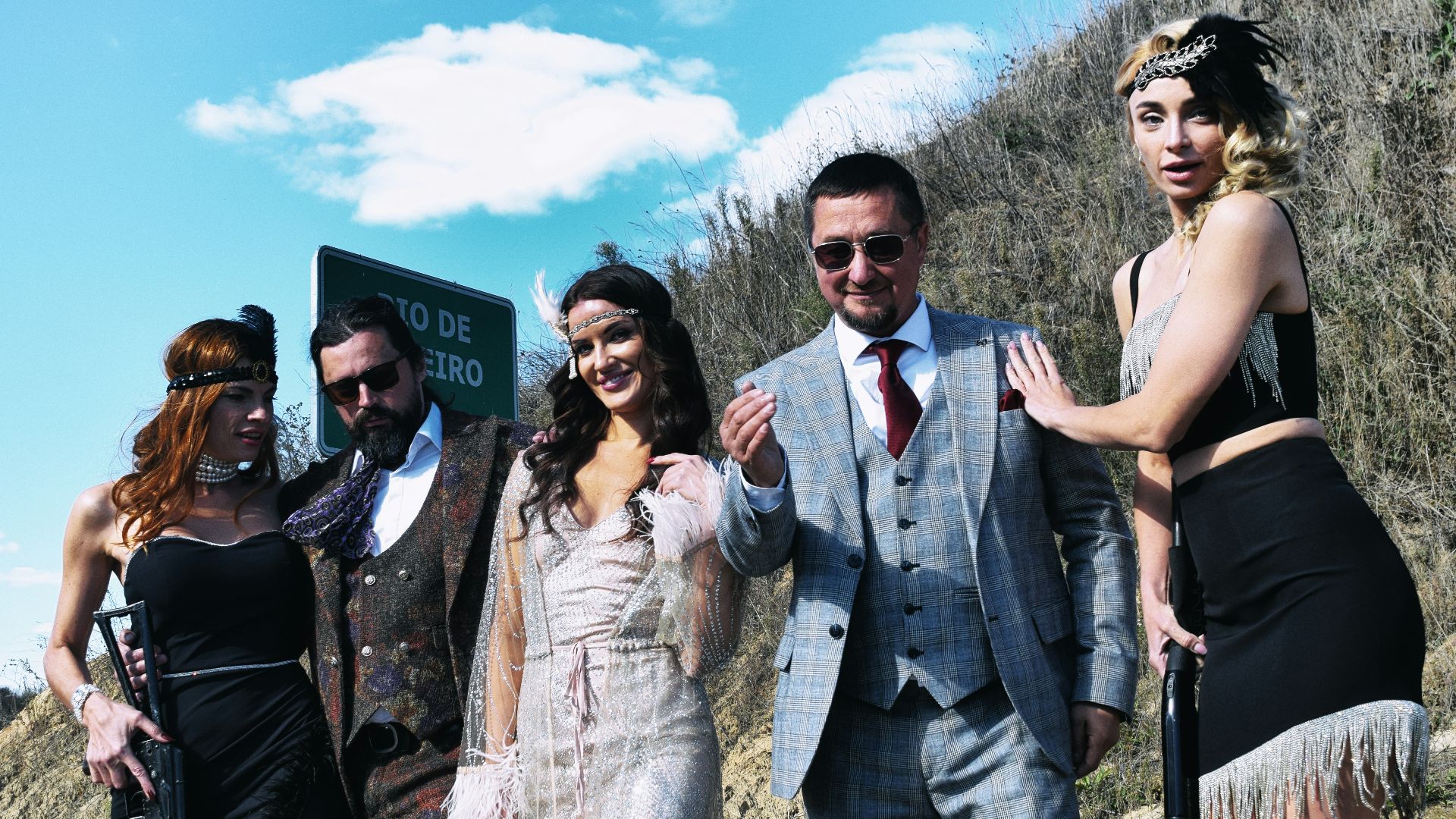 Group in vintage attire with firearms