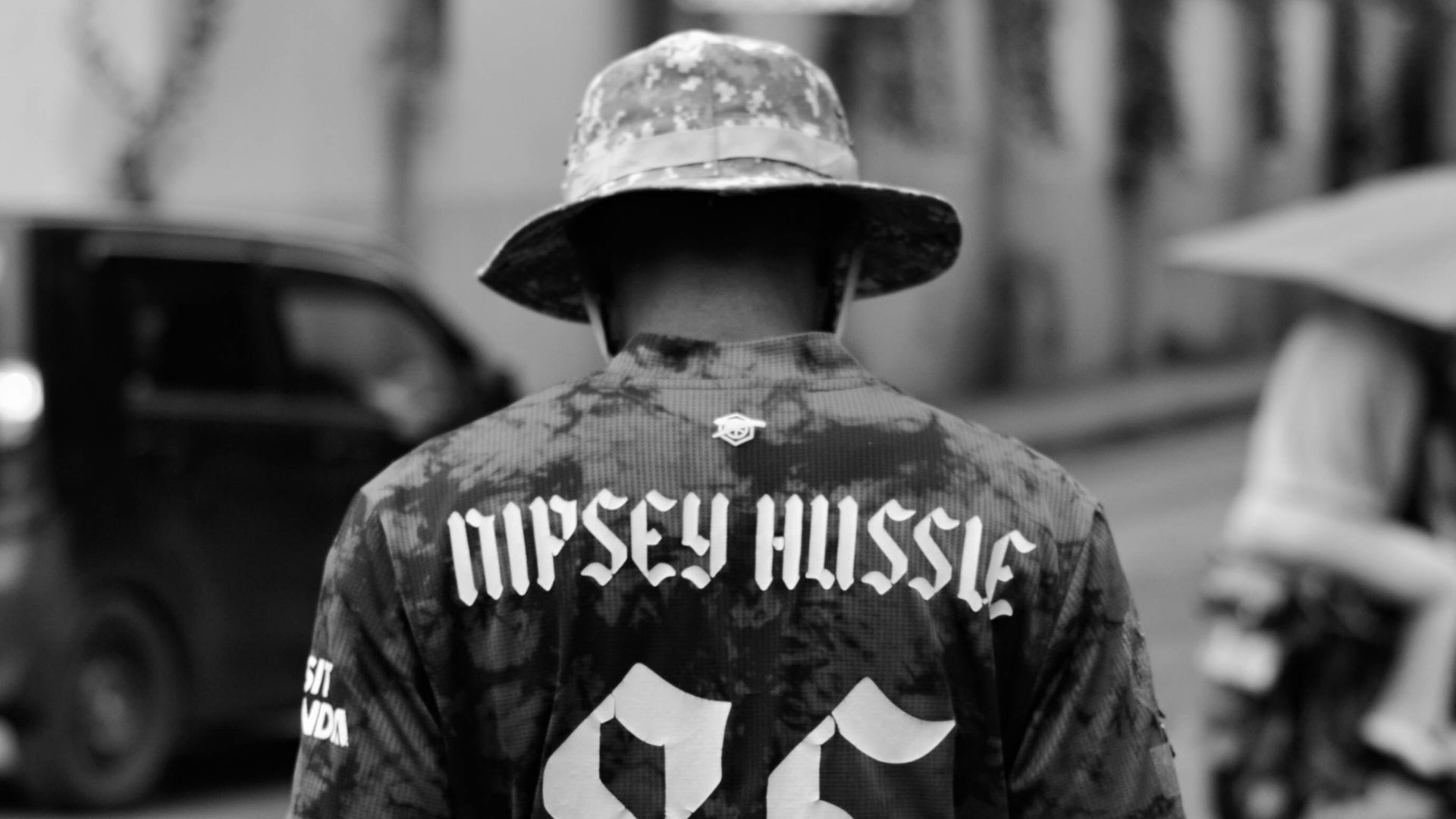 Man wearing a nipsey hussle jersey with number 85