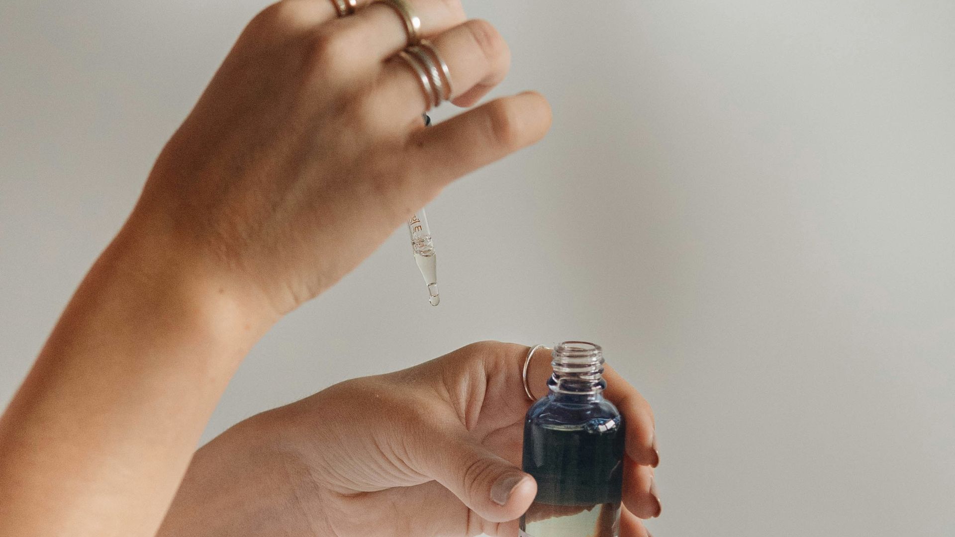 person holding black glass bottle