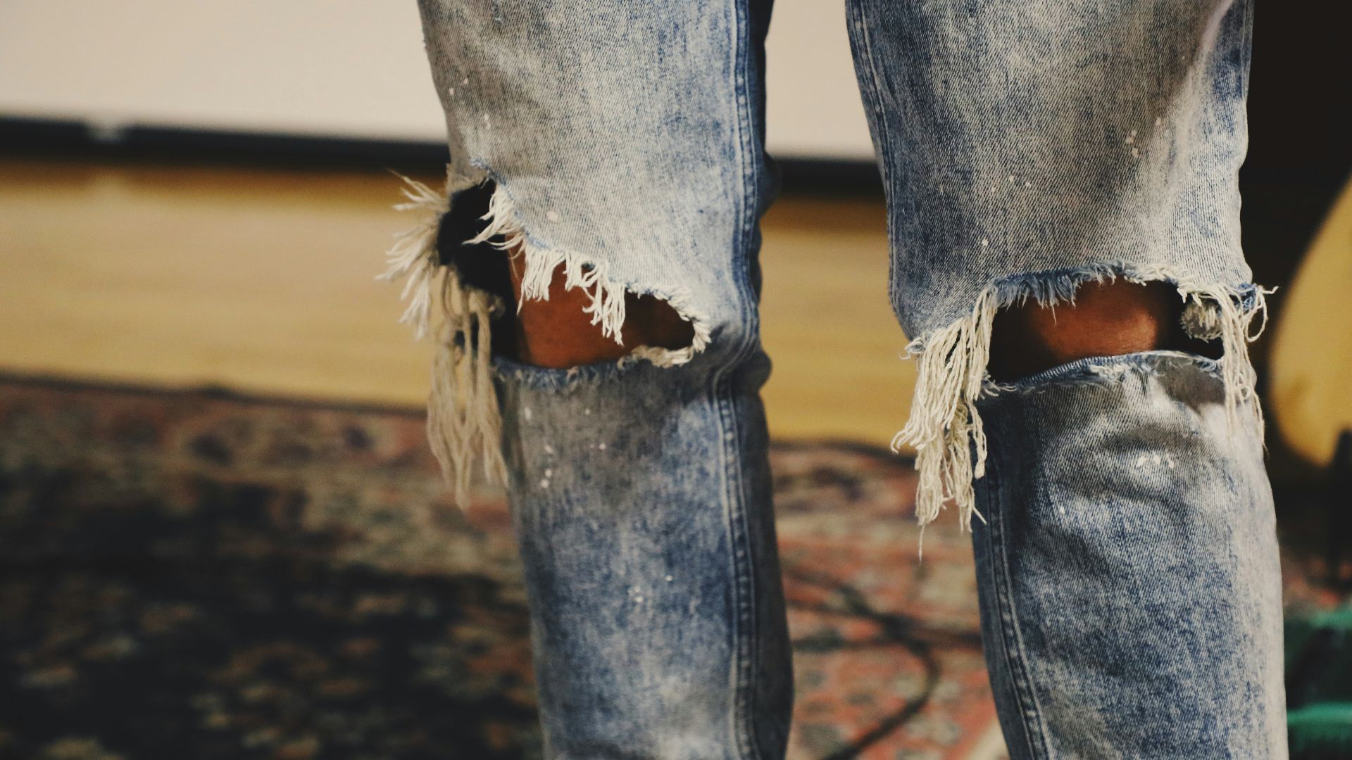 person standing on floral area rug