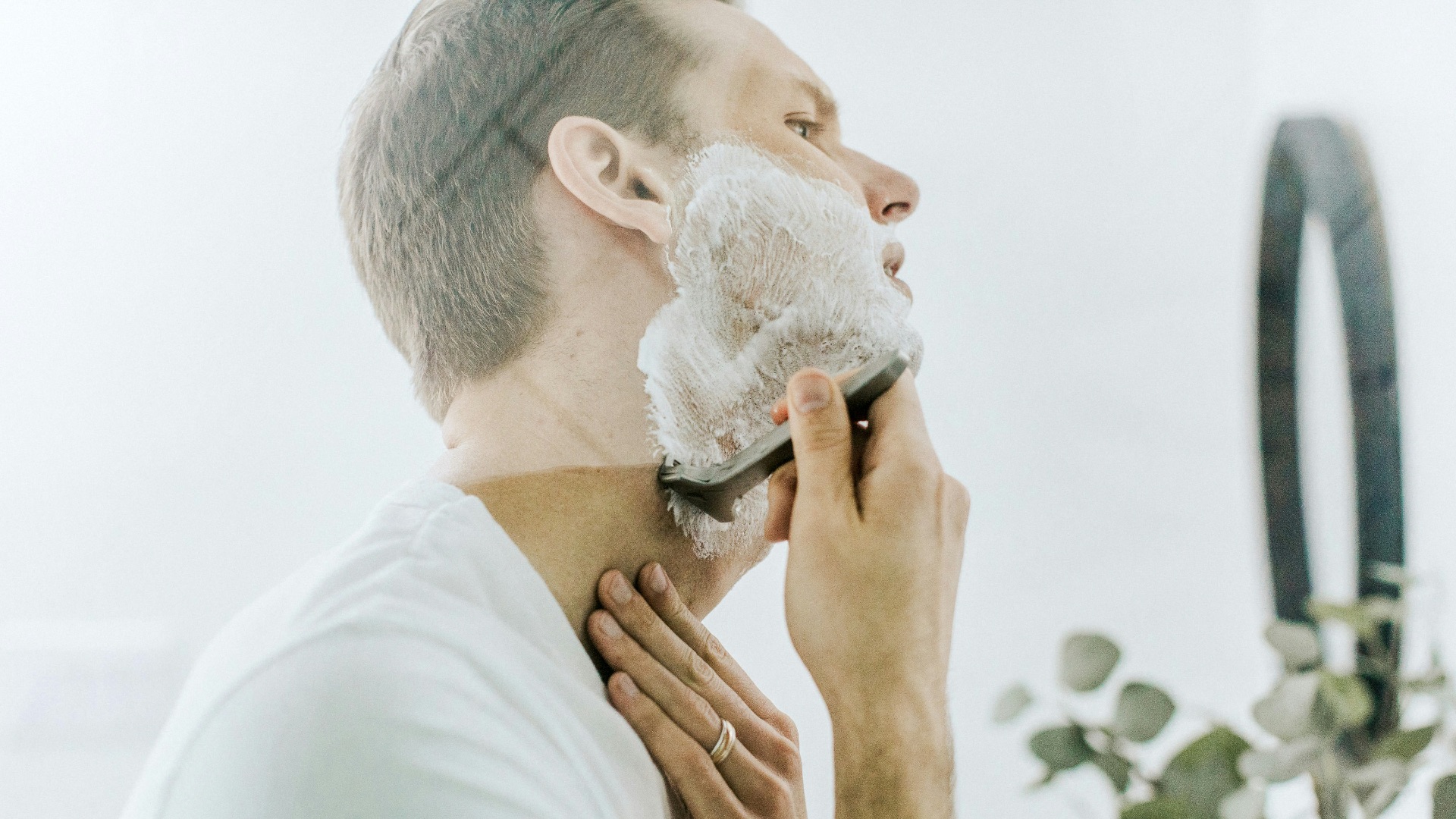 man shaving his beard