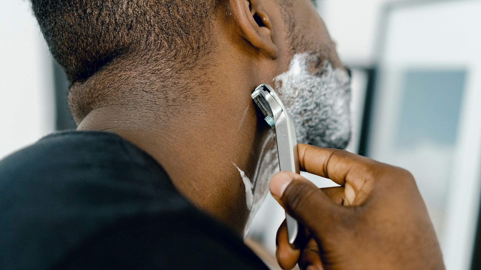 man shaving himself