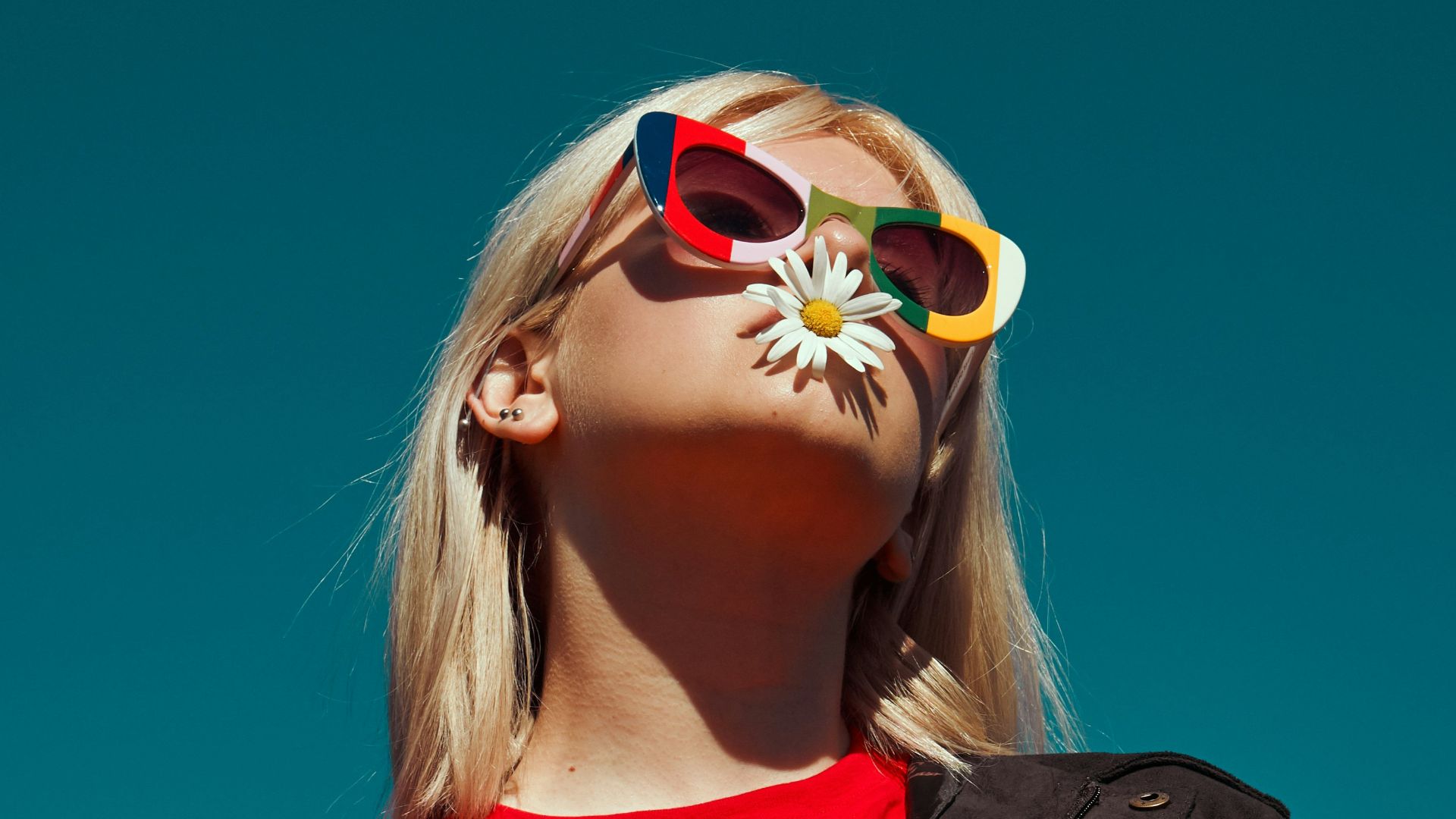 woman with sunglasses standing outdoor during daytime