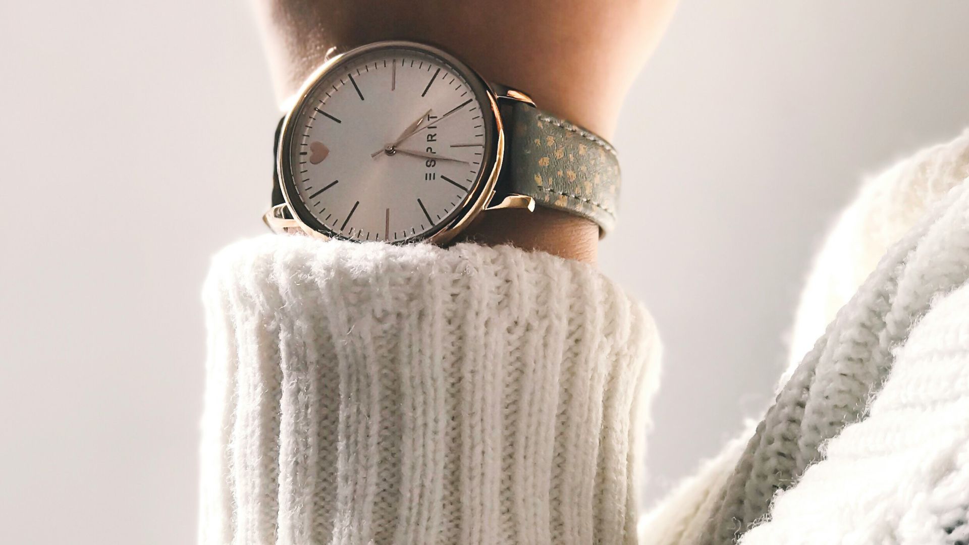 person wearing round silver-colored analog watch