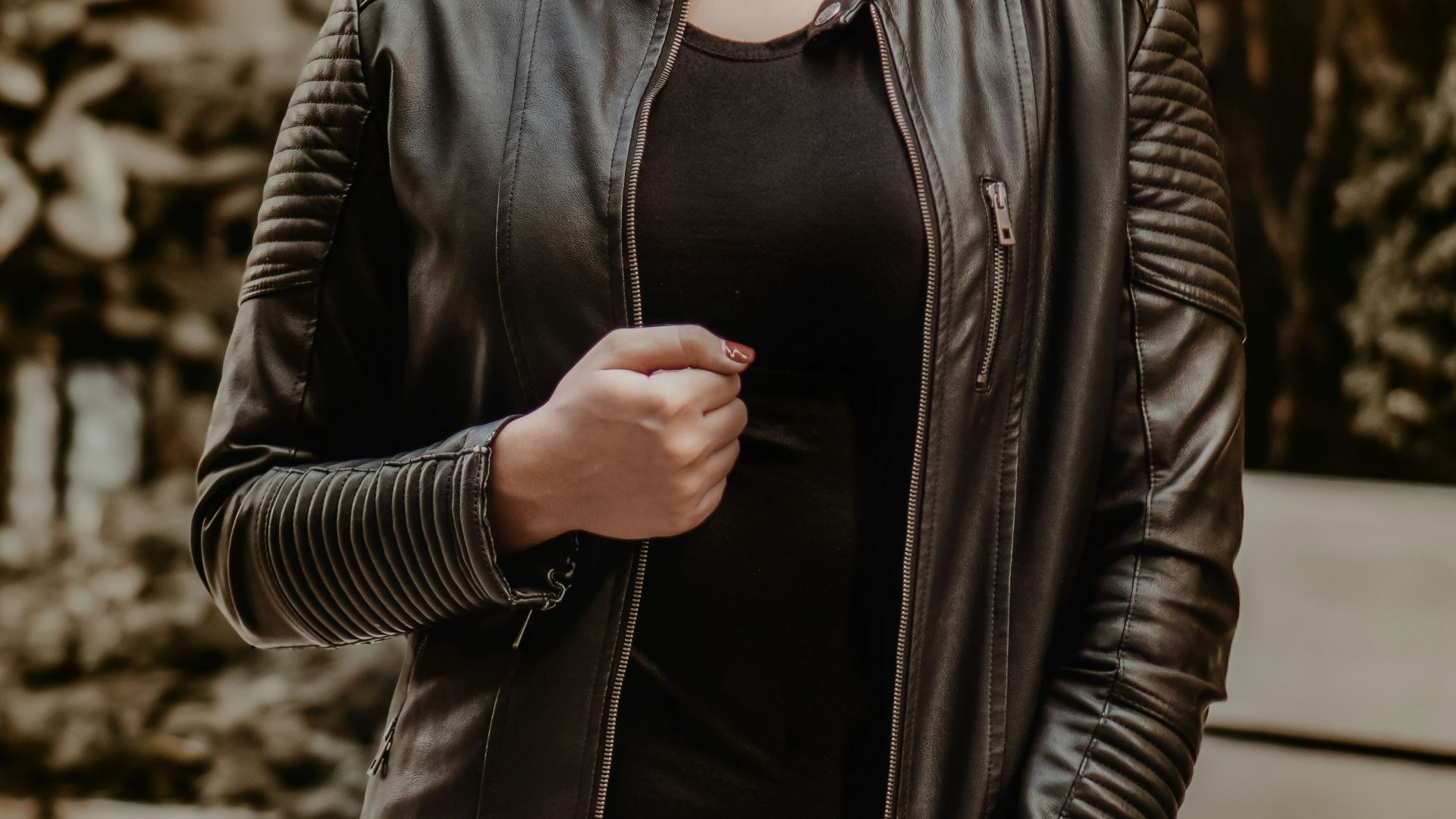 woman in black leather jacket wearing black sunglasses