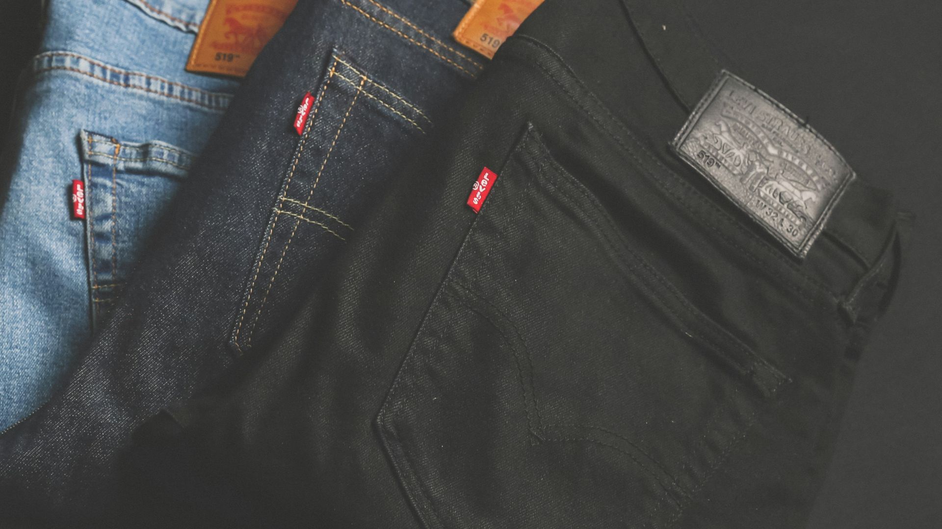 three assorted-color denim bottoms