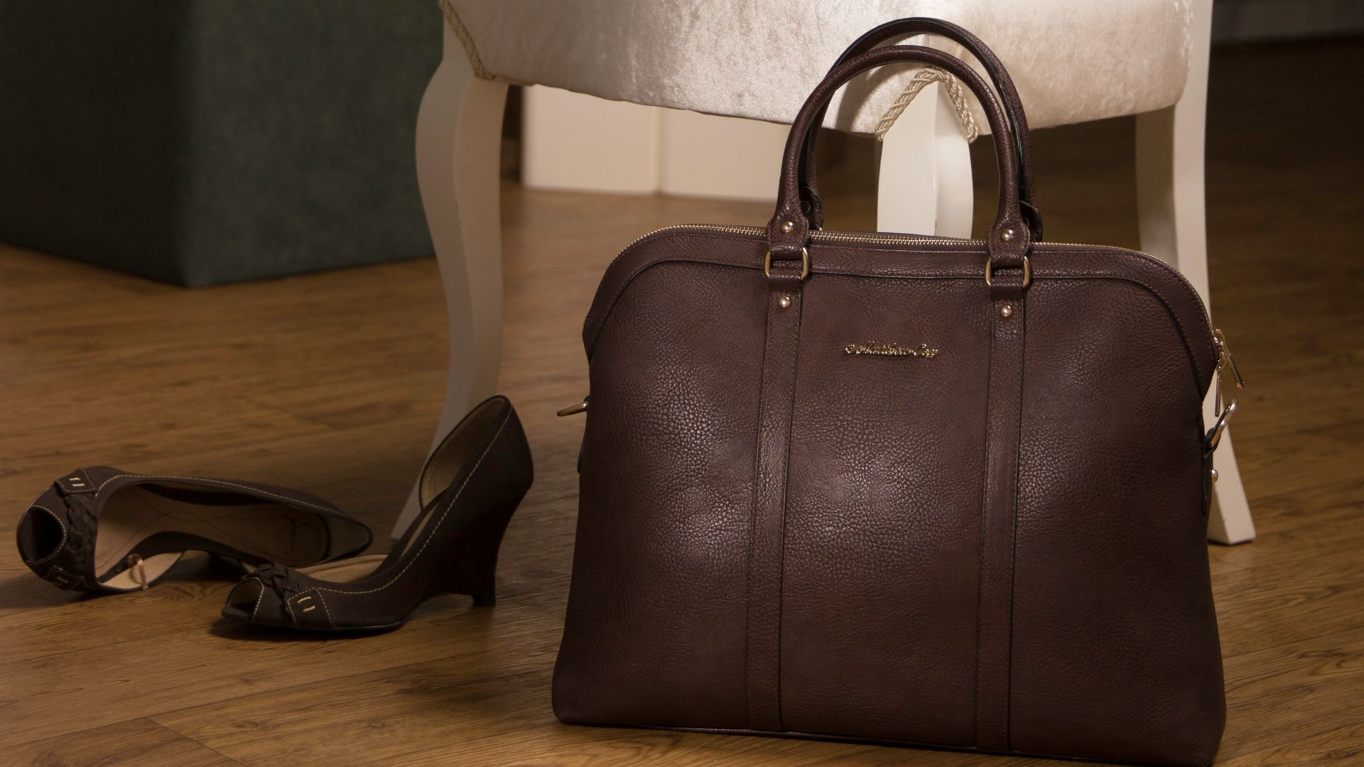 brown leather handbag near chair