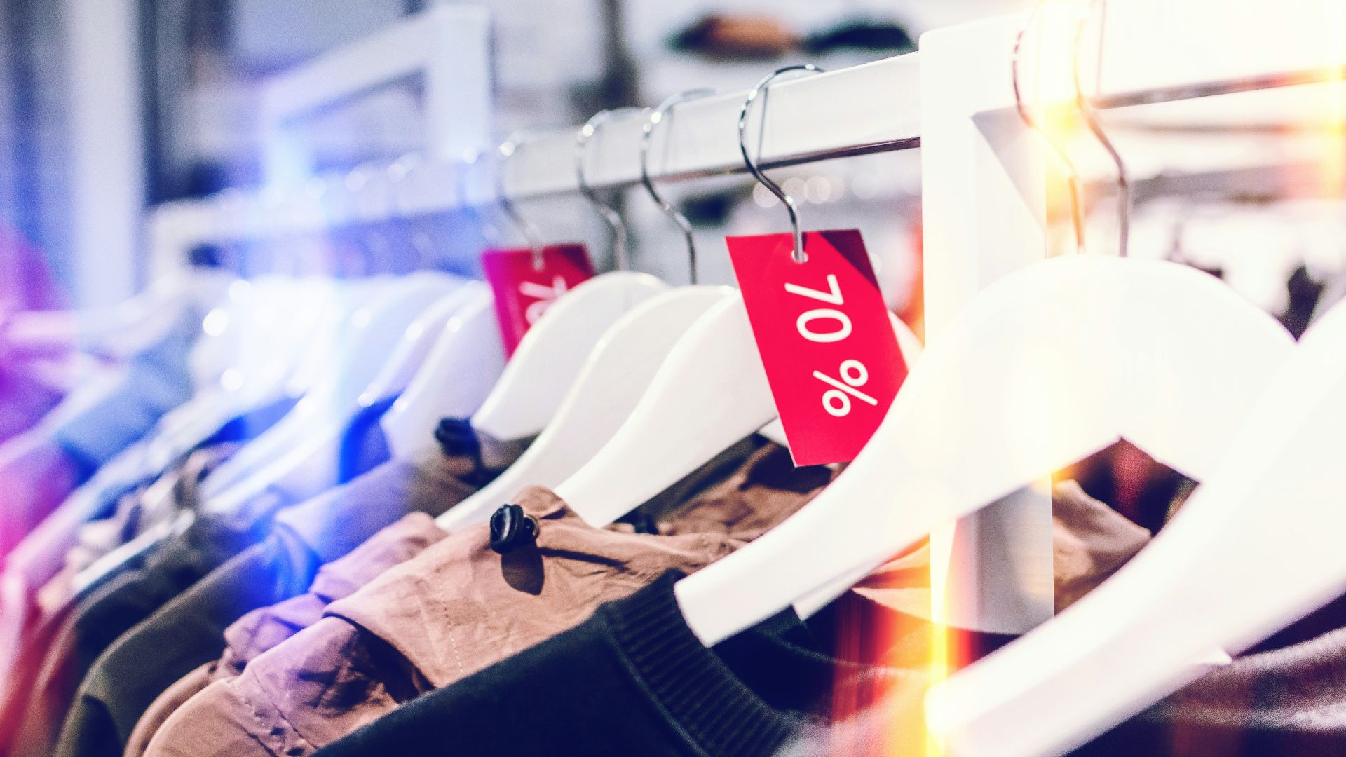 person holding white plastic clothes hanger