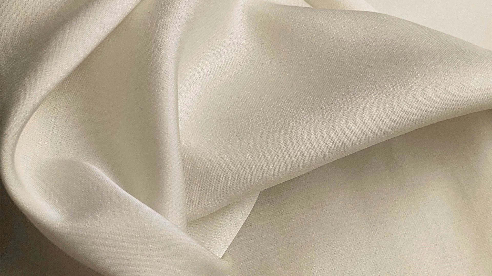 white textile on brown wooden table