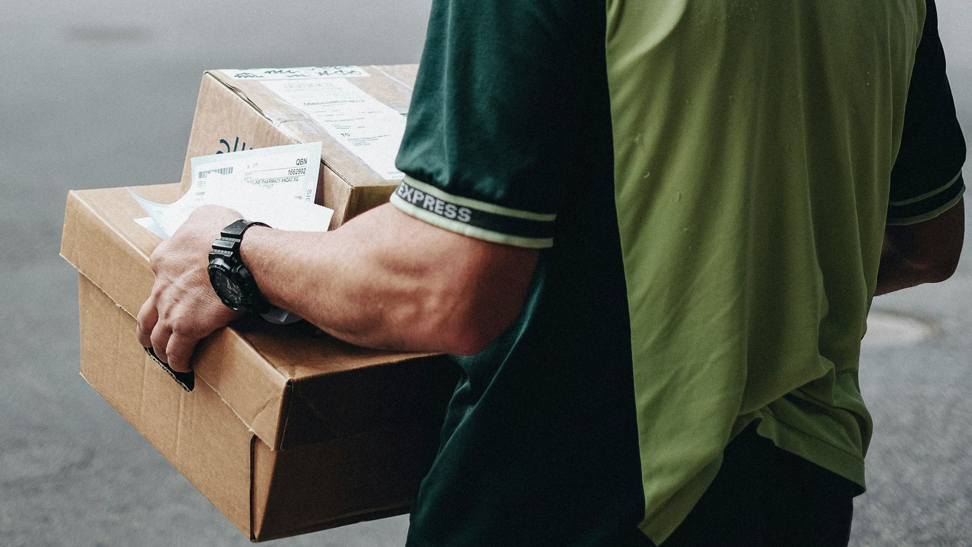 man carrying cardboard boxes during daytime