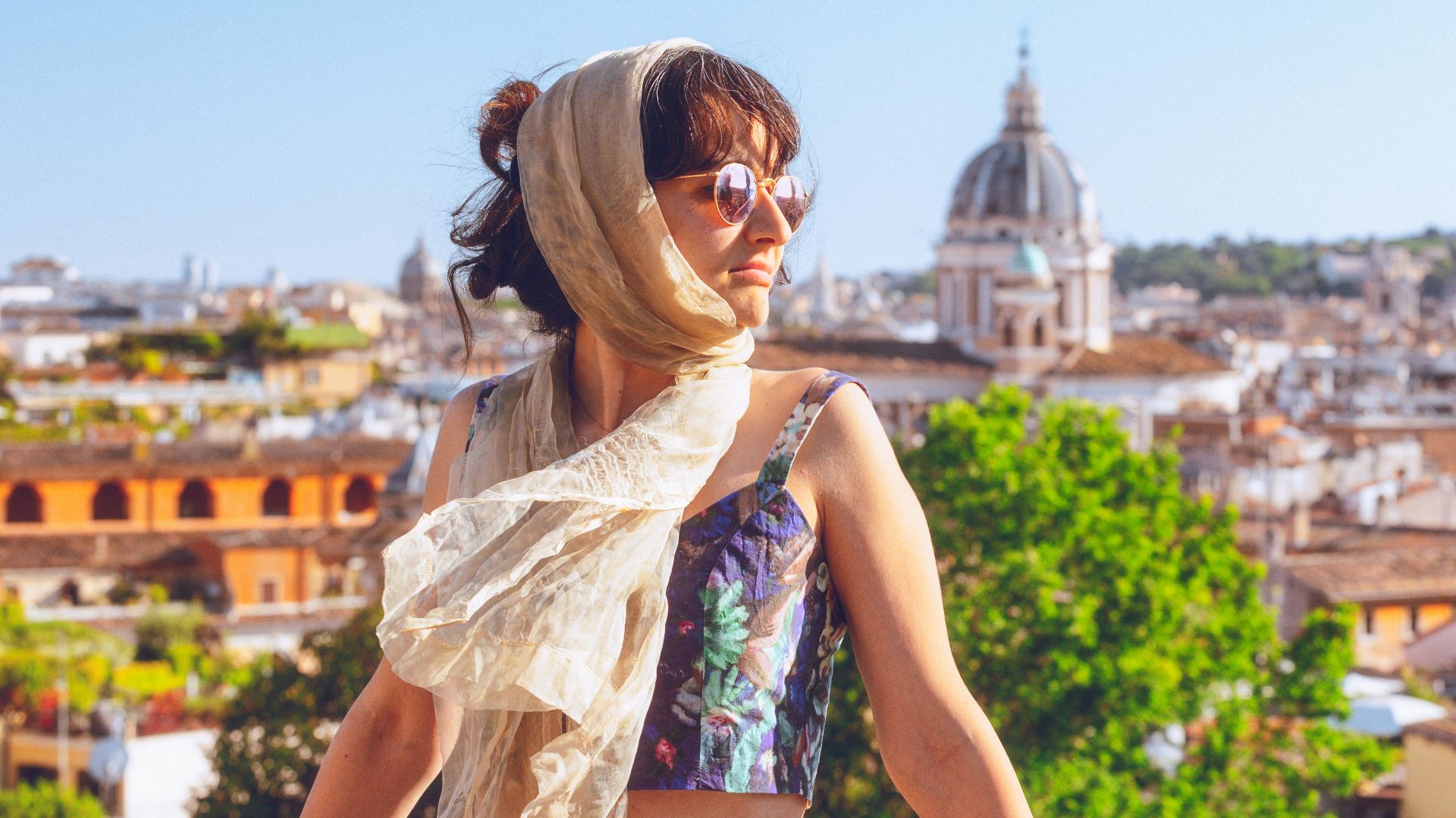a woman with a scarf on top of a roof