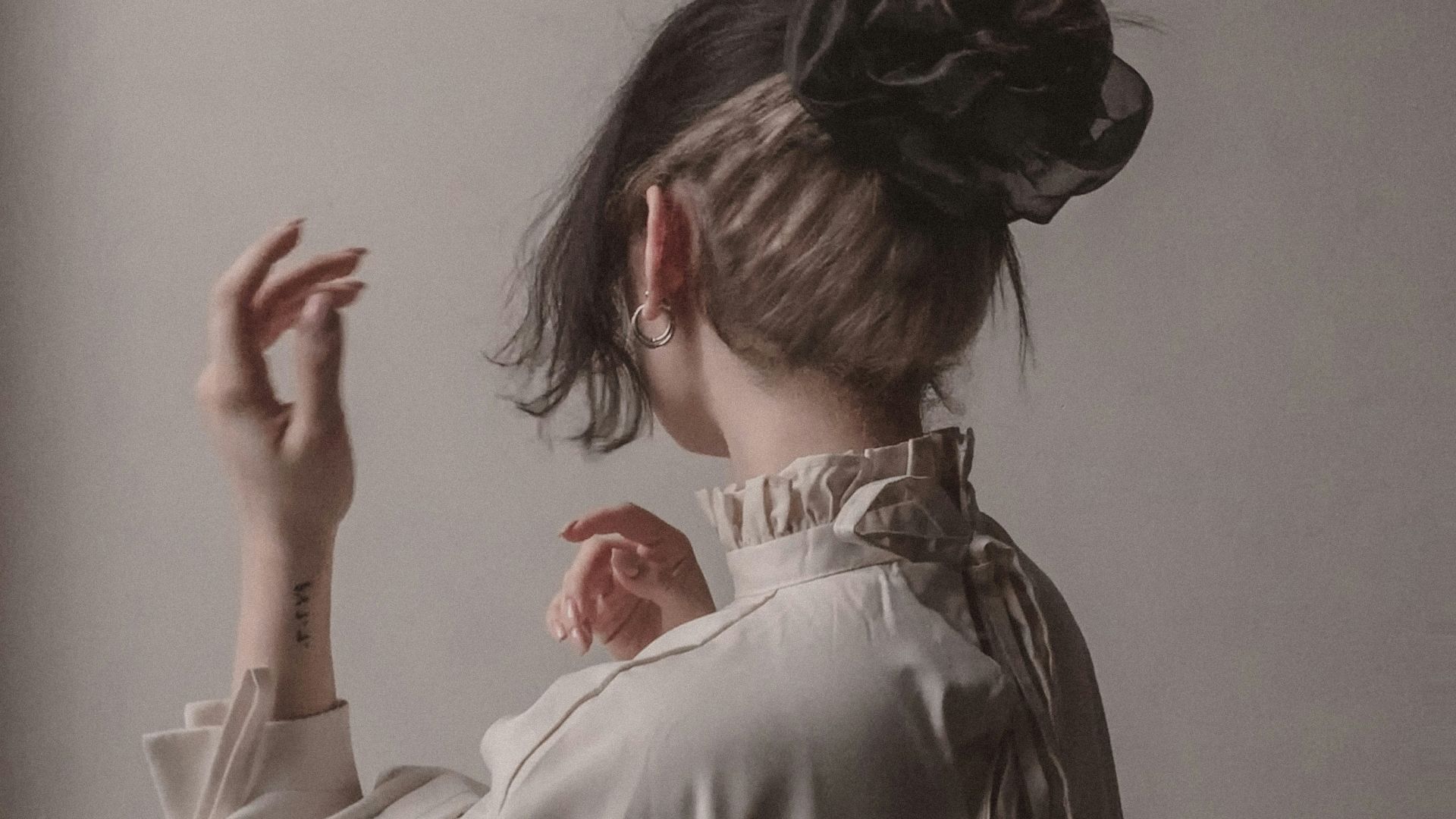 a woman in a white dress holding a string