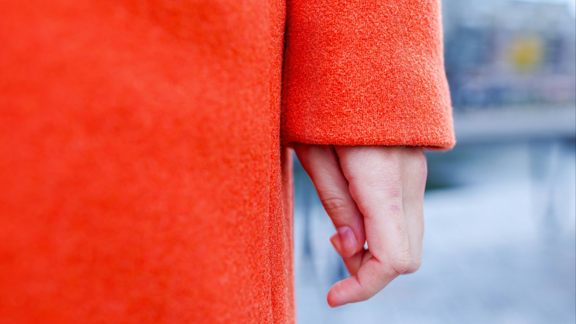 Close up of a person wearing an orange coat