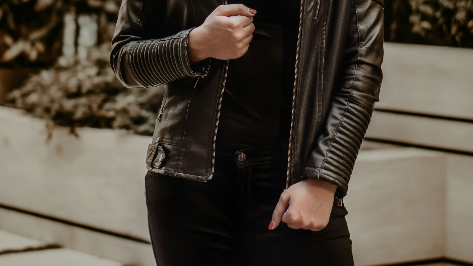 woman in black leather jacket wearing black sunglasses