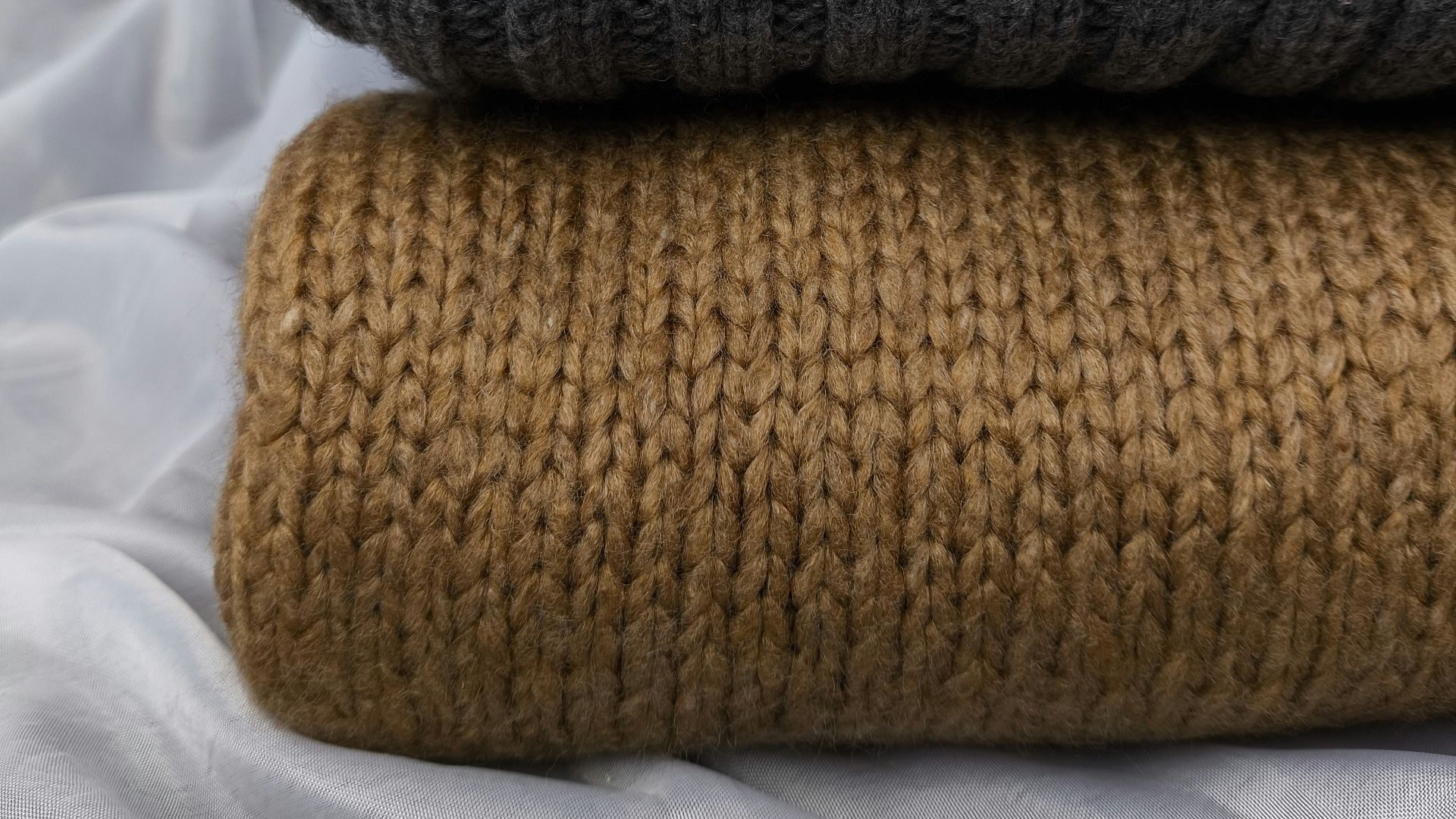 Two knitted blankets sitting on top of each other