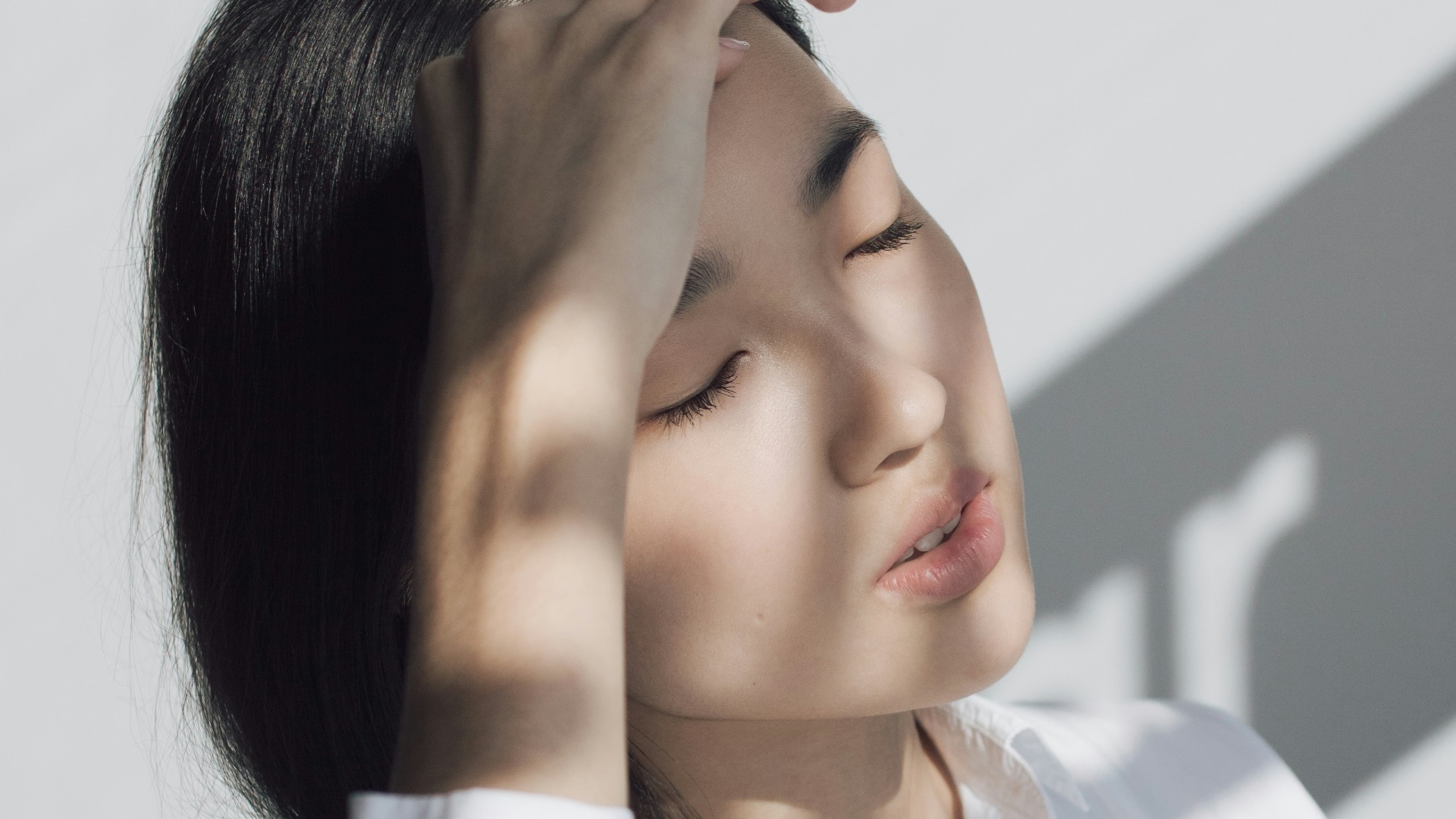 woman leaning on white table