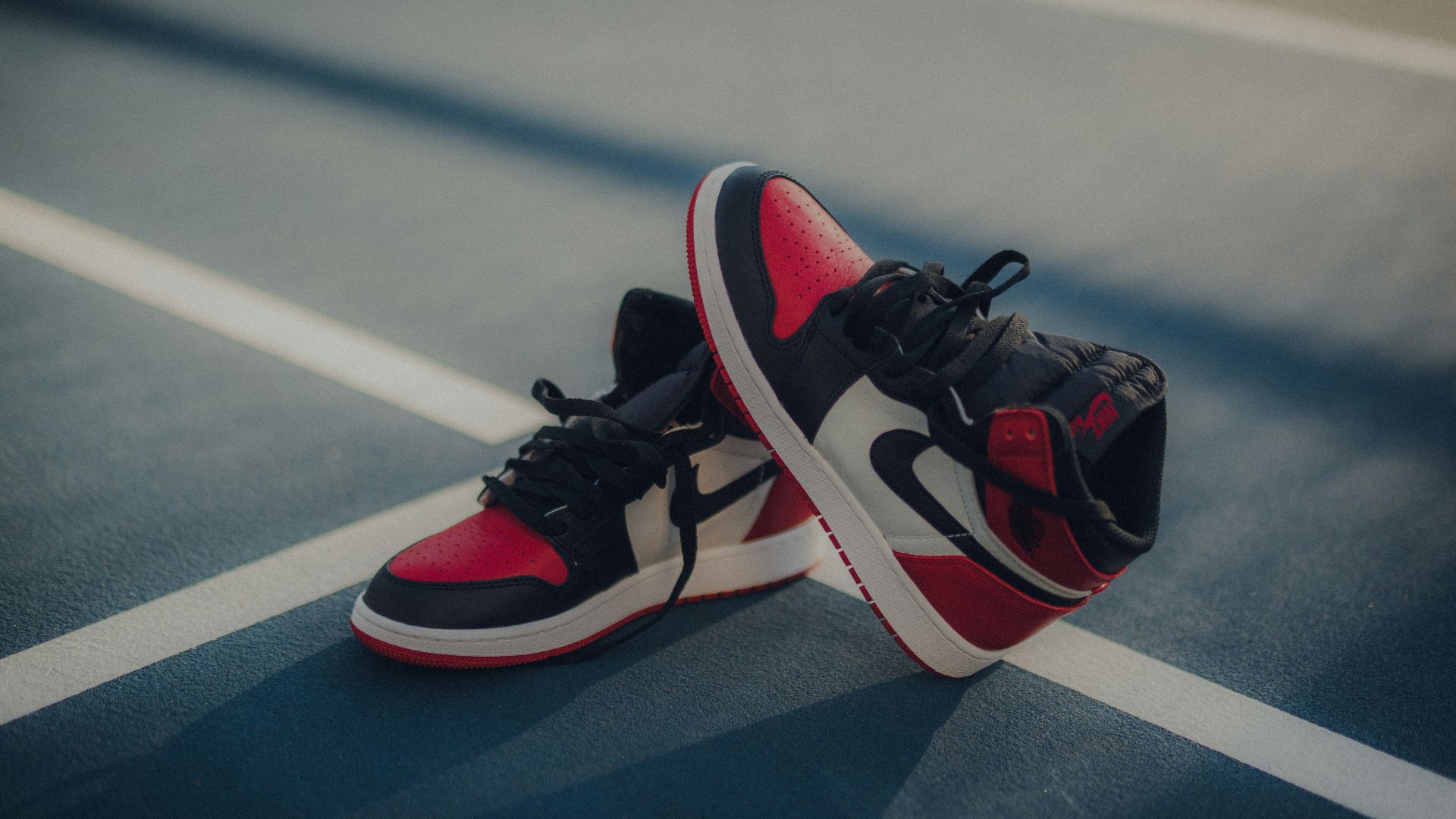 pair of black-white-and-red Air Jordan 1 shoes