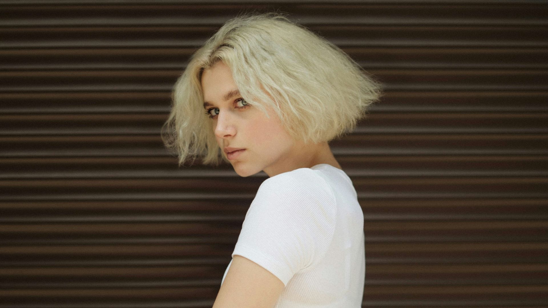 woman in white t-shirt and black and white striped skirt