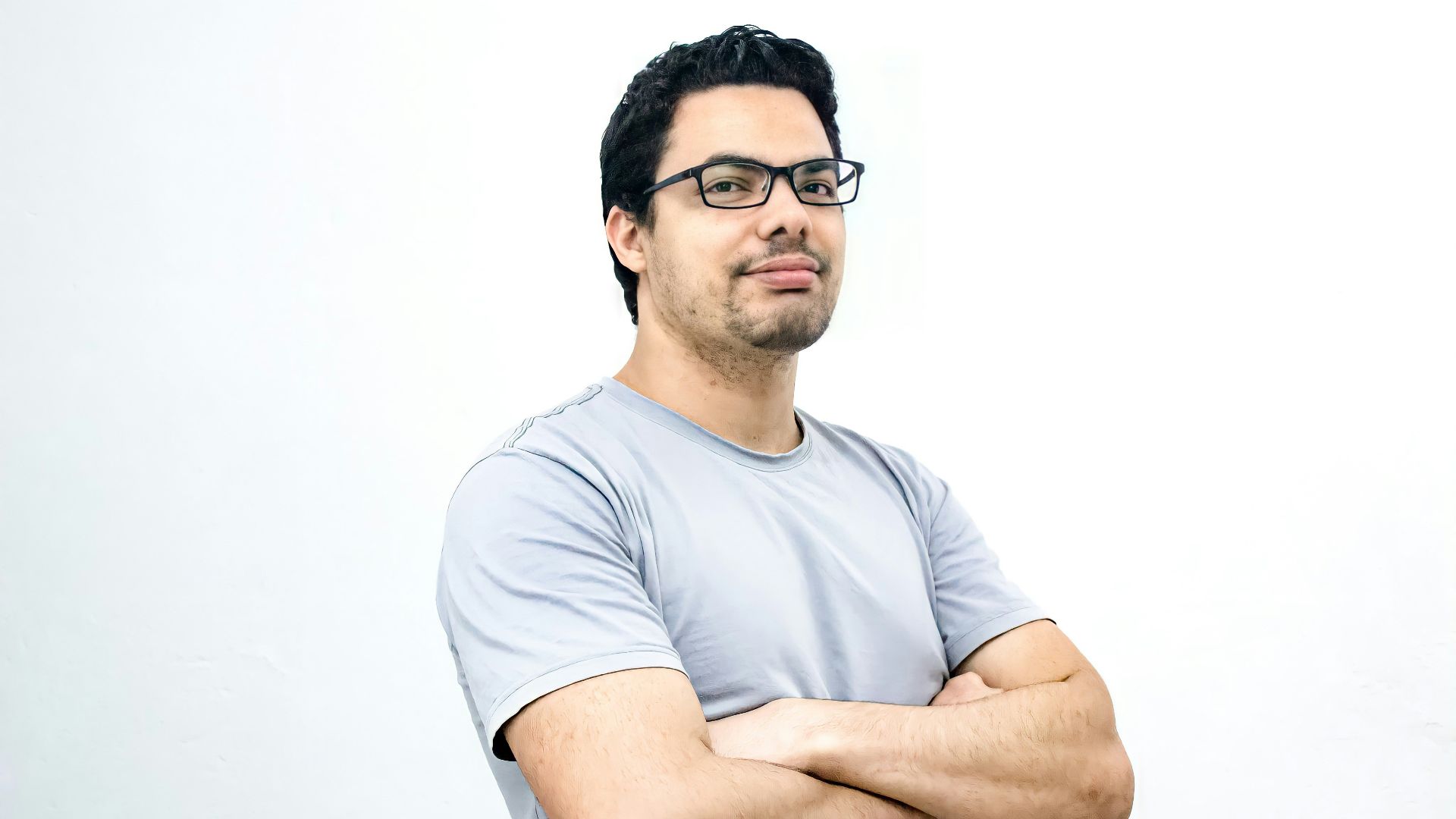 man in white crew neck t-shirt wearing black framed eyeglasses