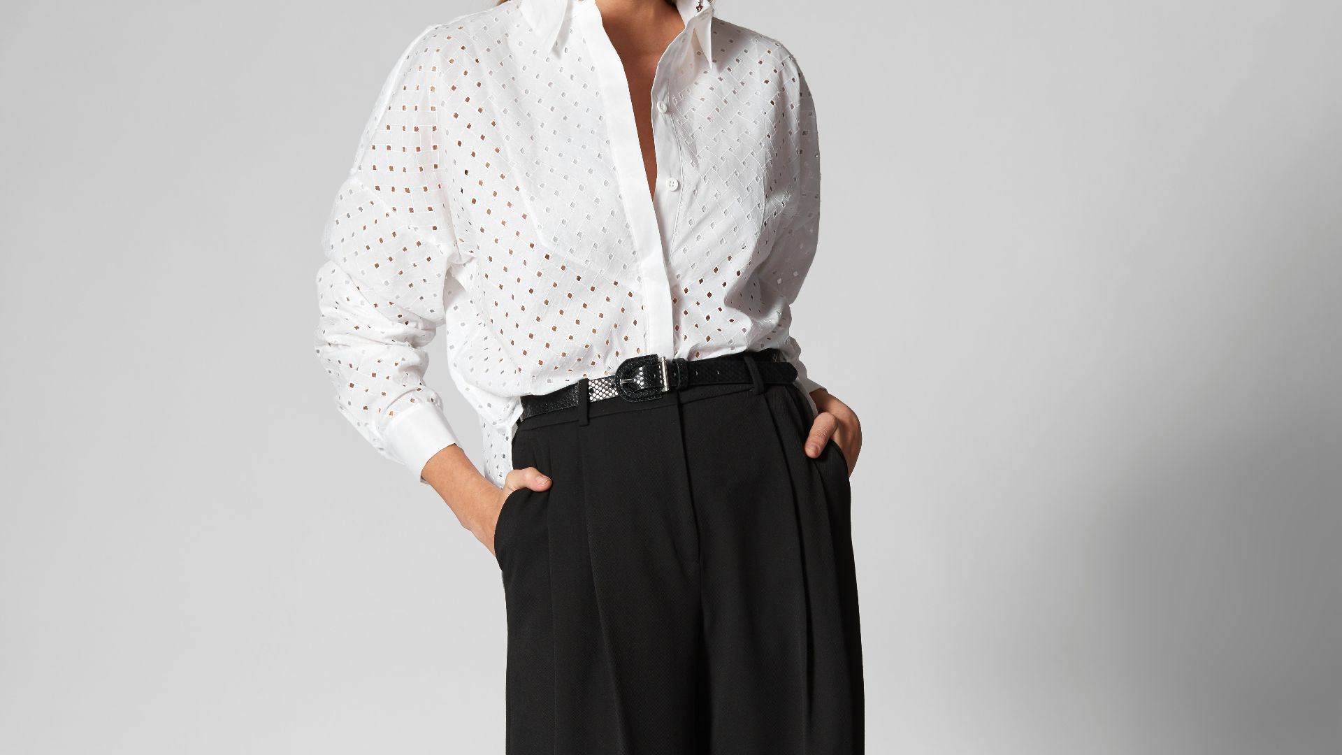 Woman in white shirt and black wide-leg pants.