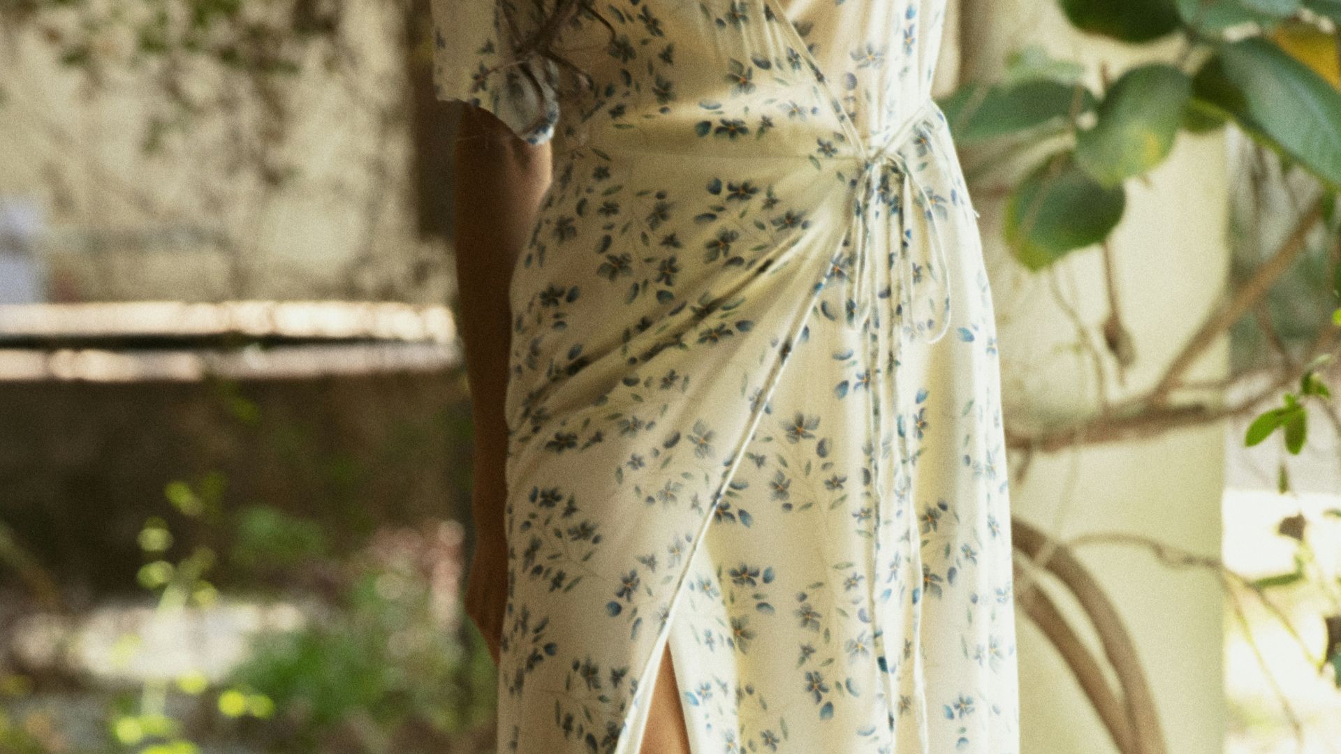 Woman in a floral wrap dress with a high slit