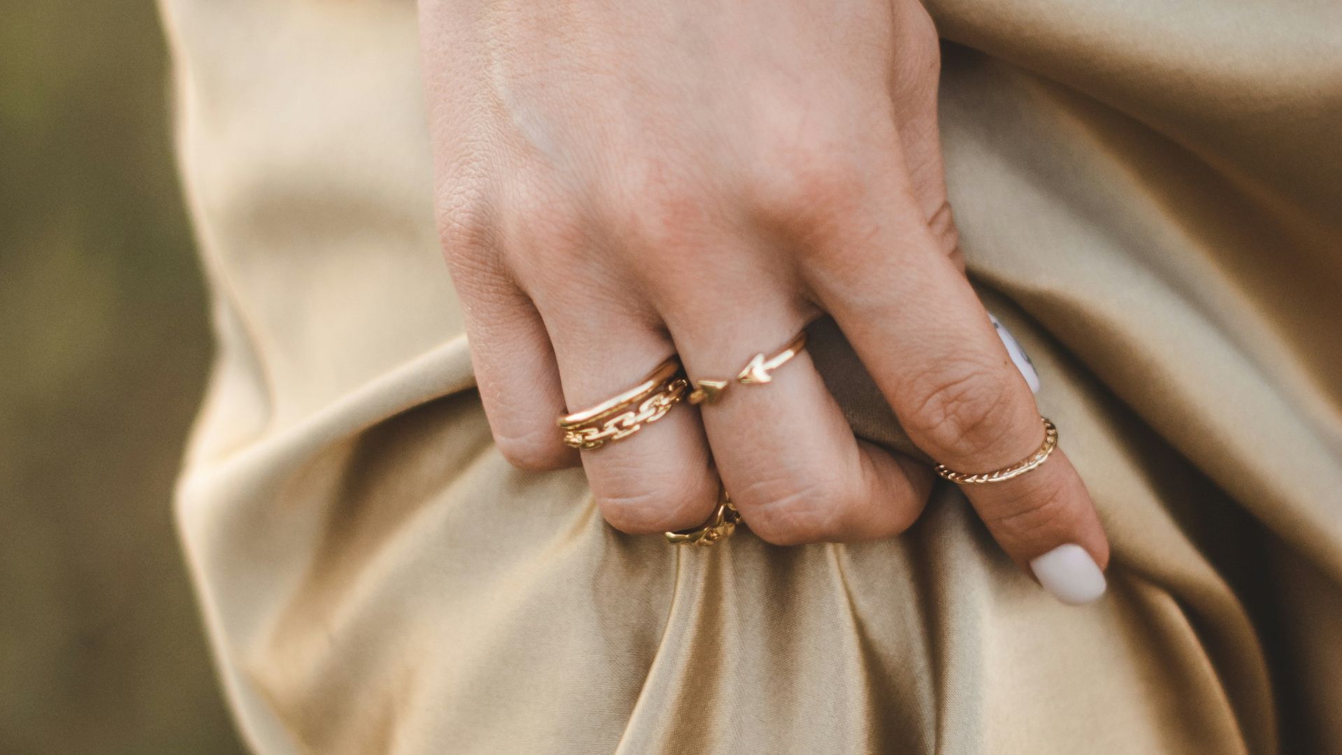 person wearing gold ring and gold ring