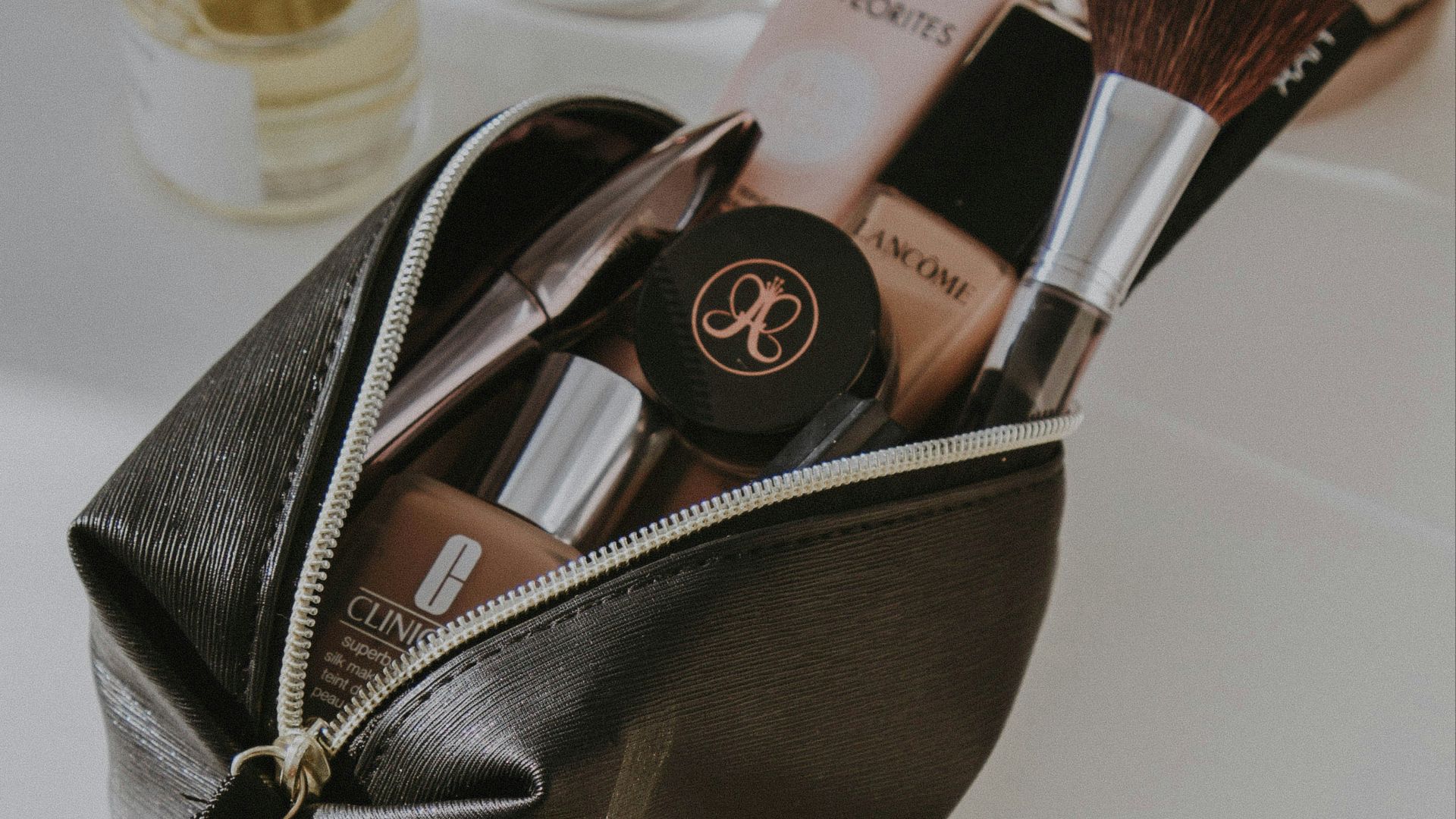 black leather bag with makeup brushes and makeup brushes