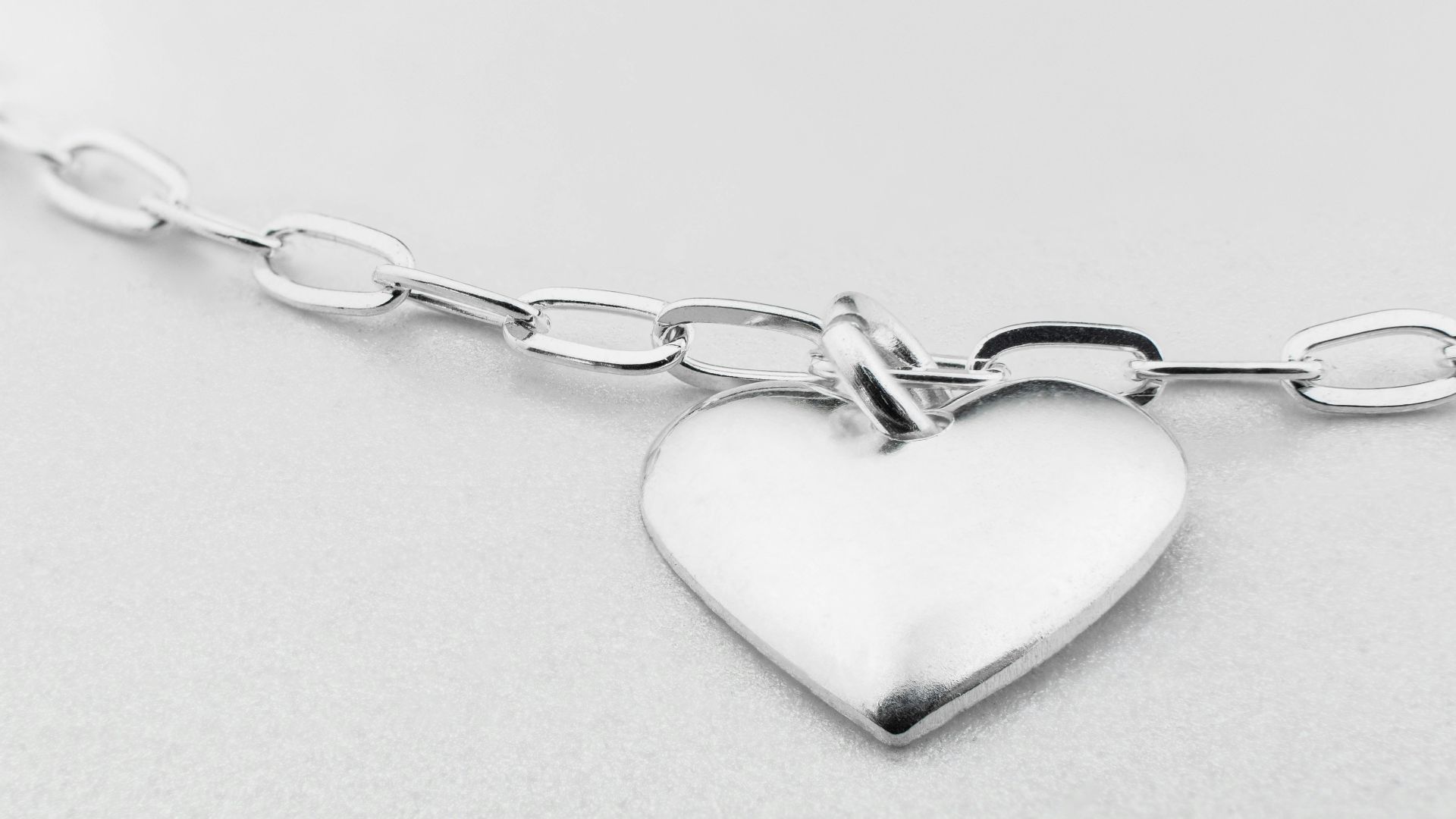a silver heart charm on a silver chain