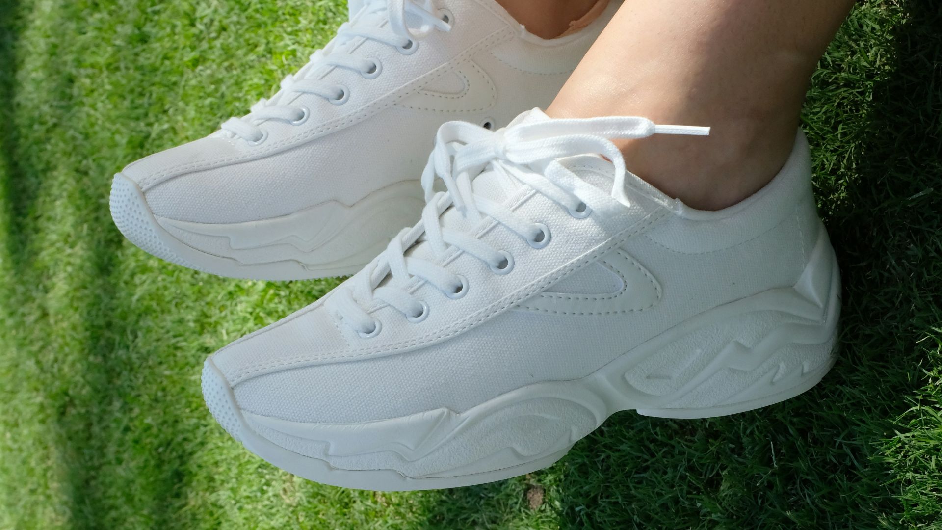 person wearing white nike air force 1 low