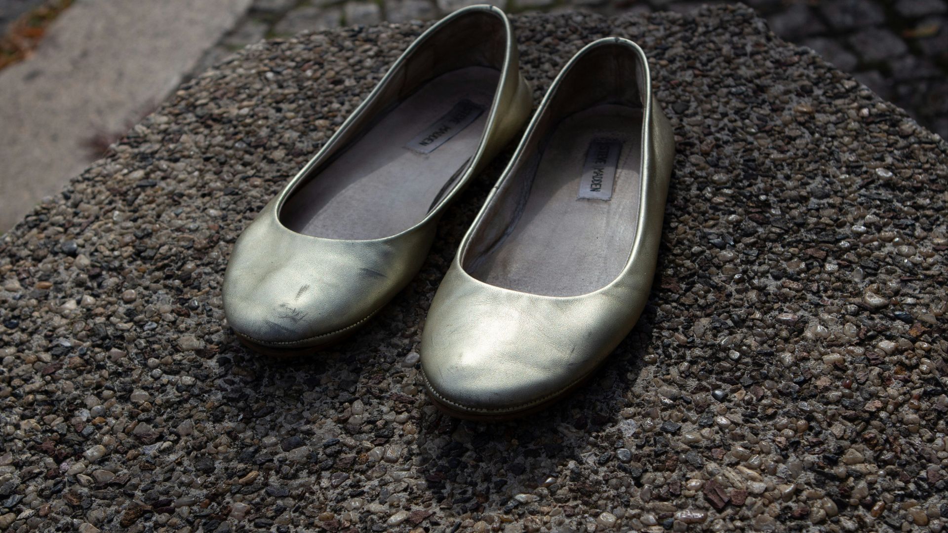 a pair of shoes on a gravel surface