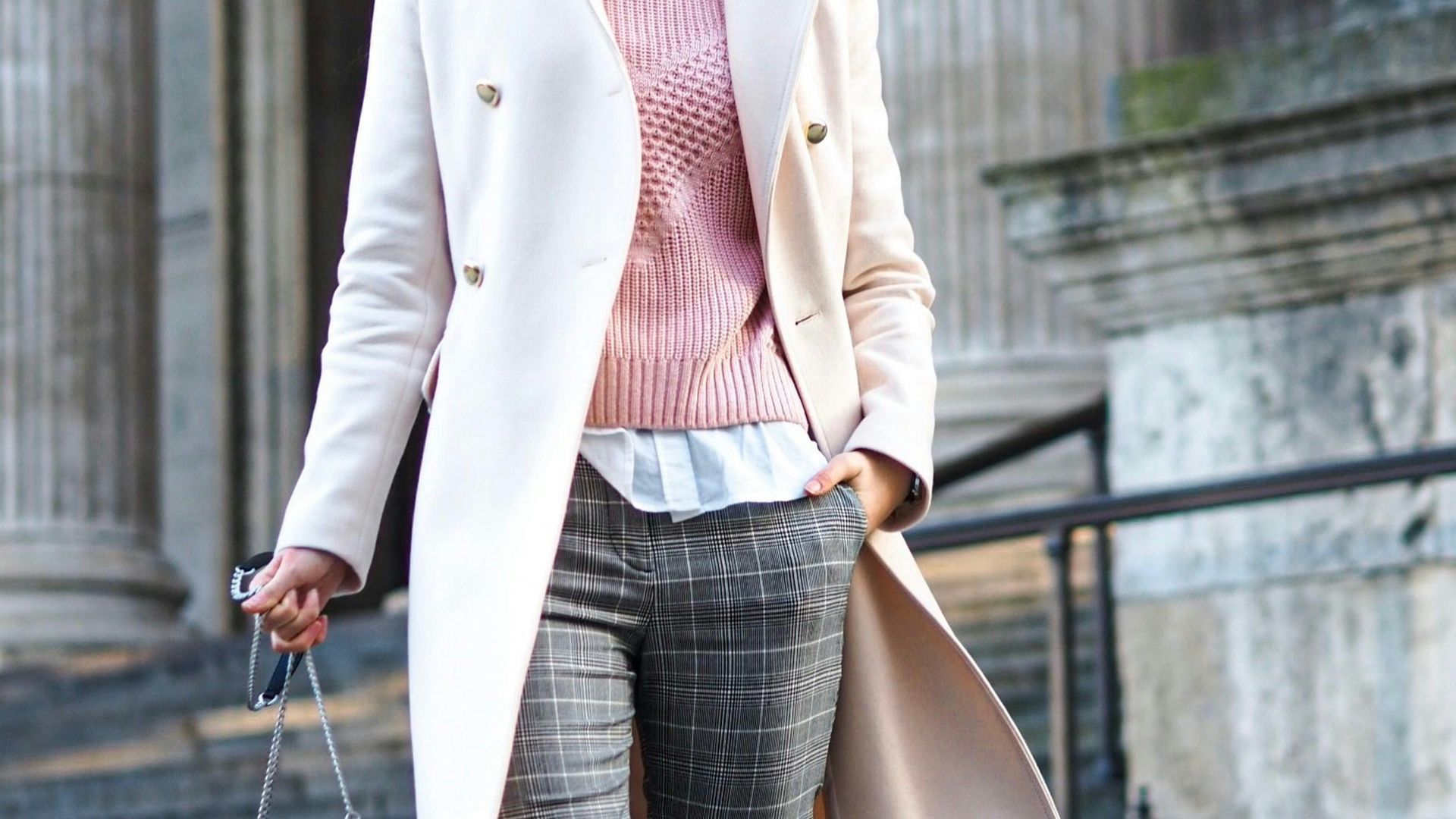 woman wearing white coat carrying crossbody bag