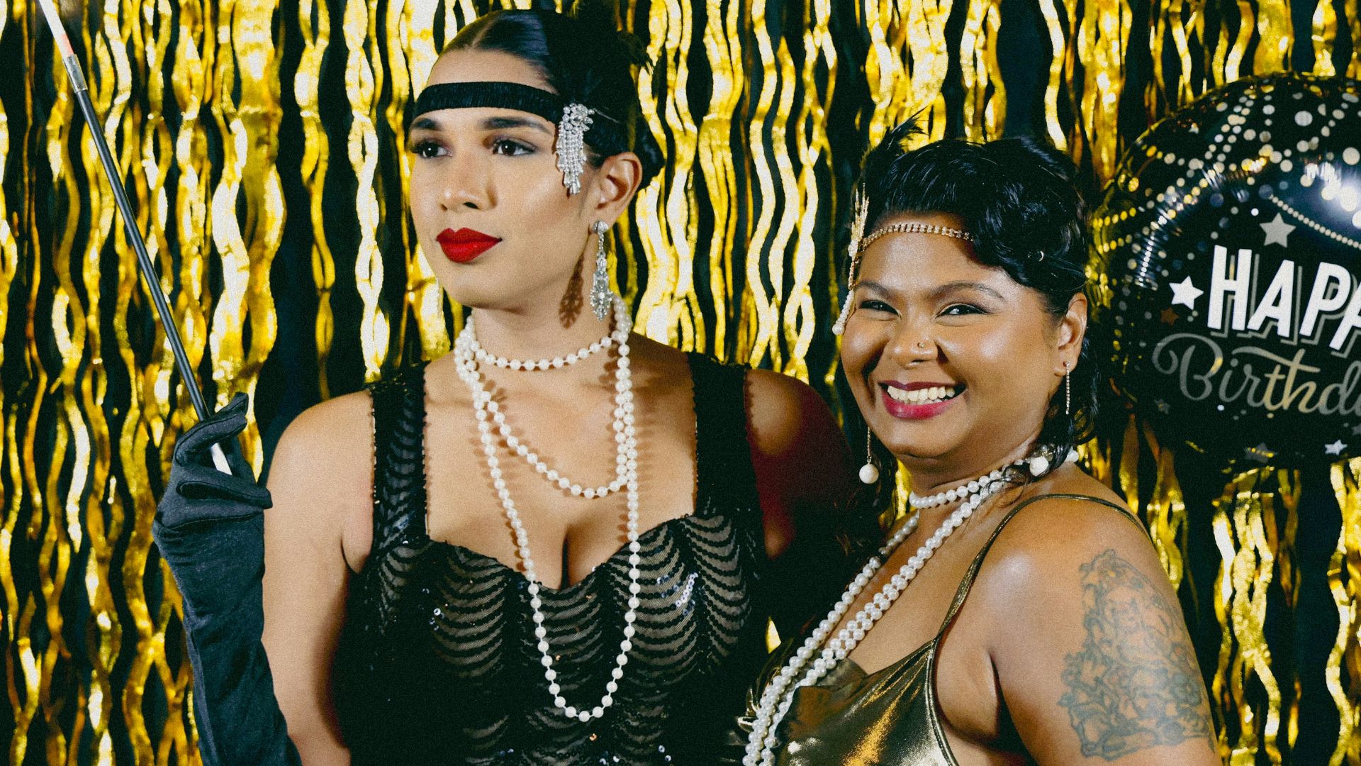 Two women dress up for a roaring twenties party.