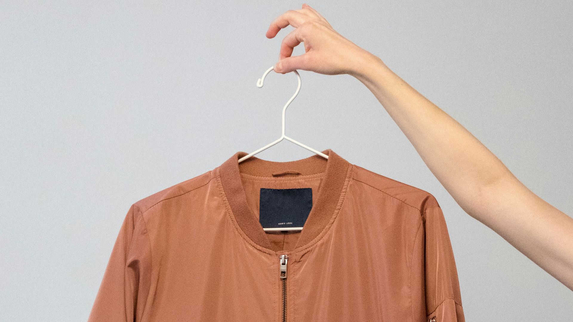 brown long sleeve shirt on white clothes hanger