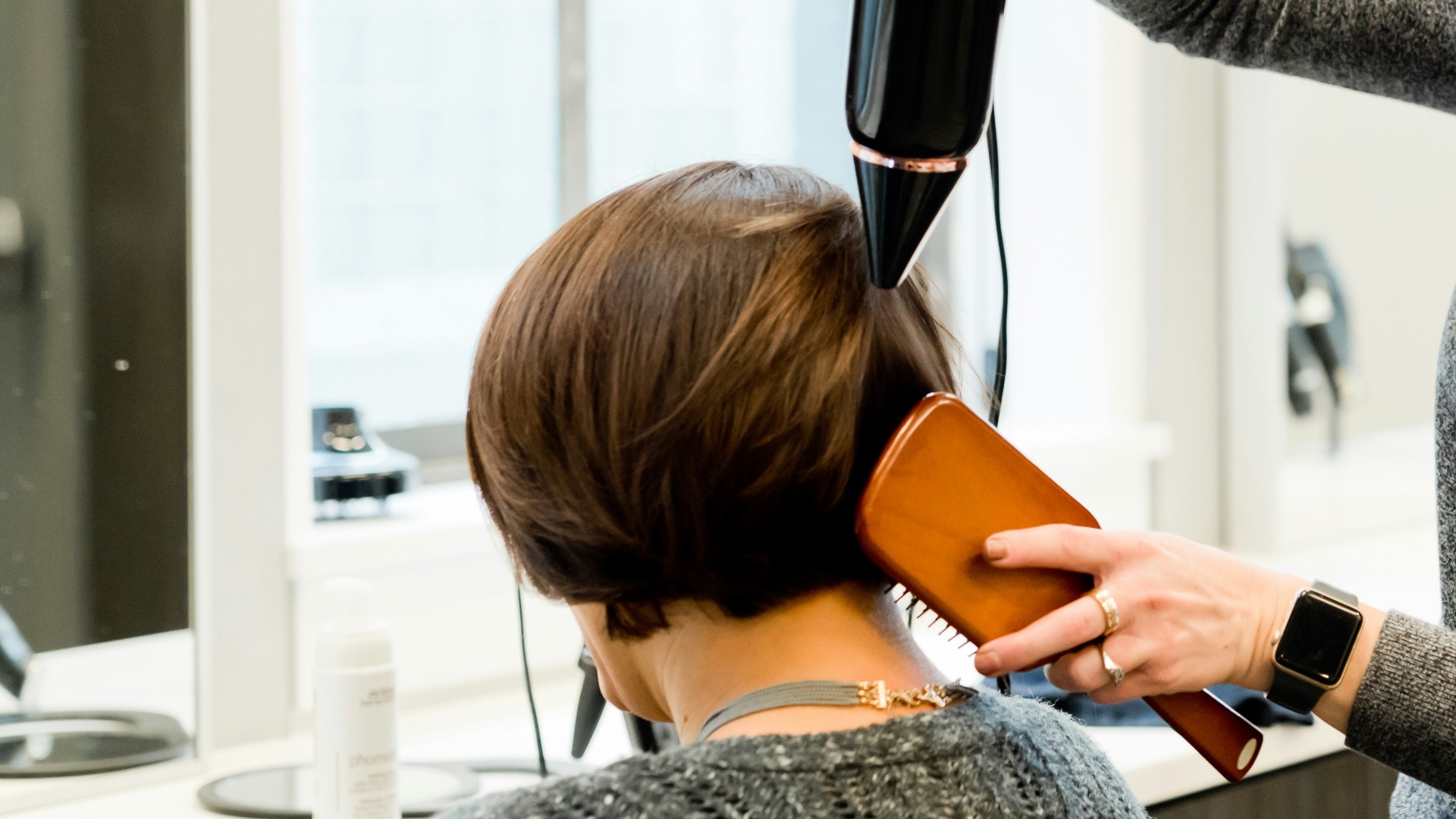 woman holding hair dryer