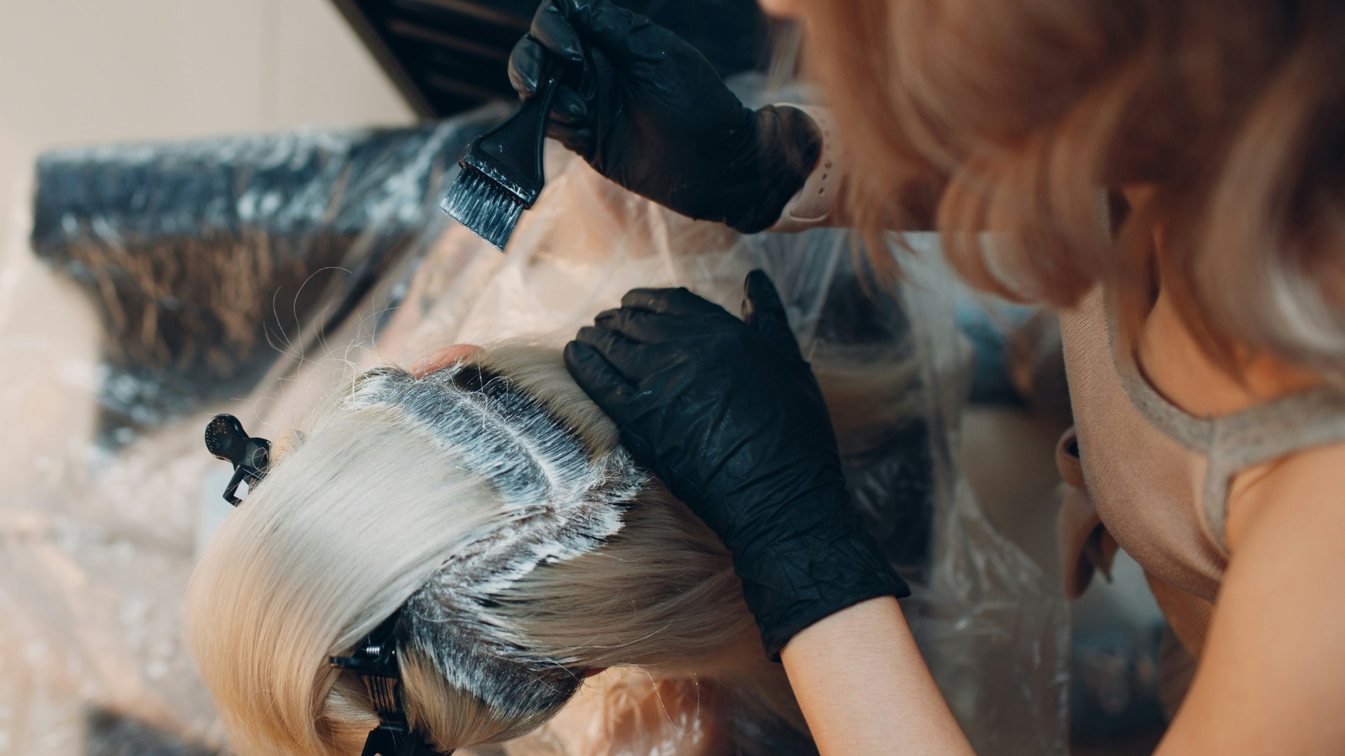 woman in black shirt lying on white textile