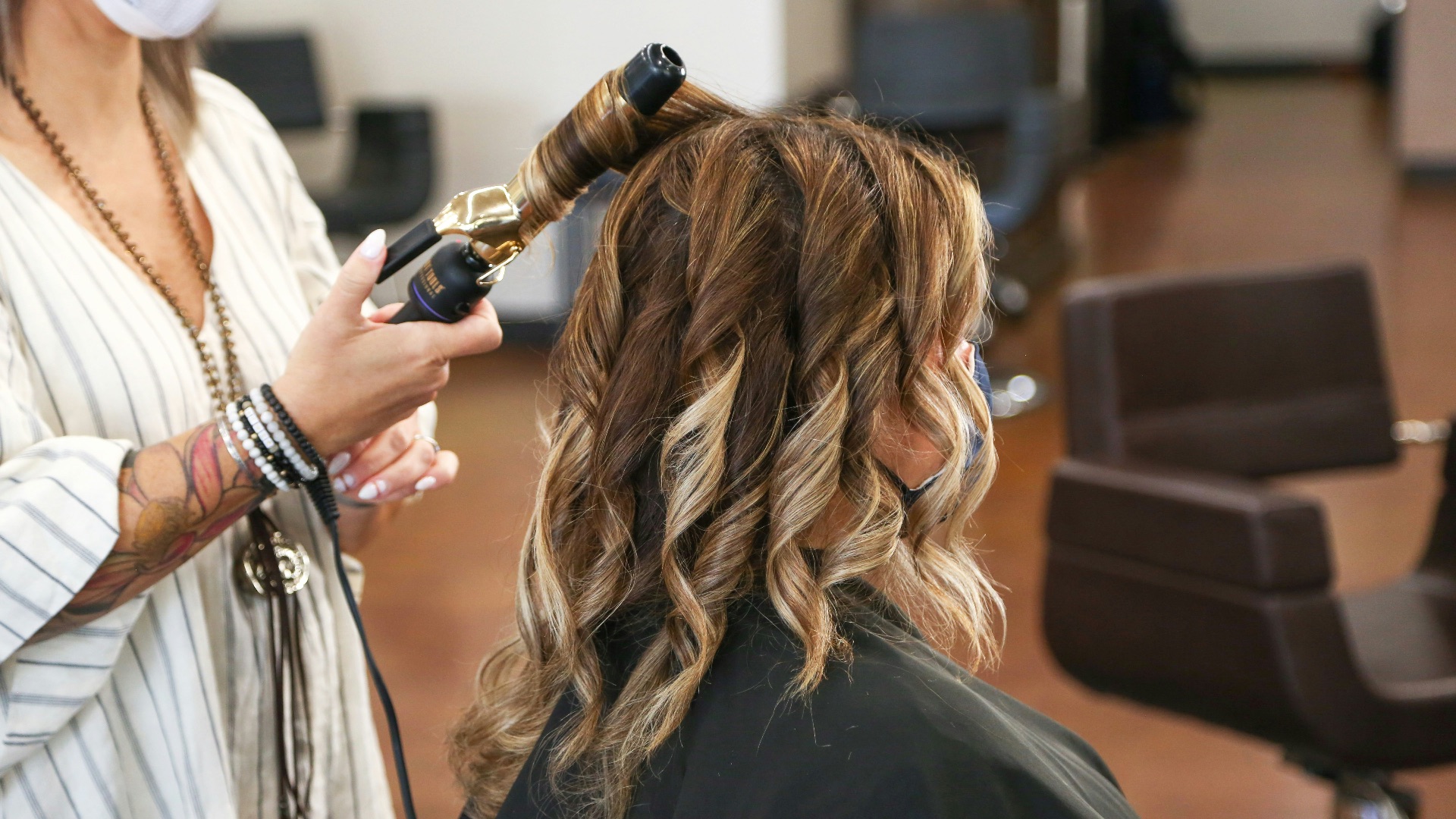 woman in black long sleeve shirt holding black smartphone