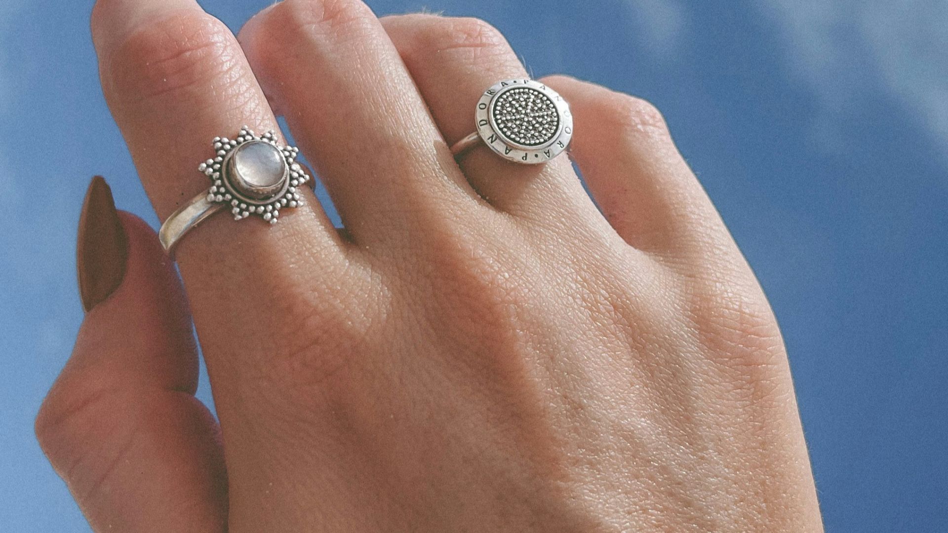 a person's hand with a ring on it