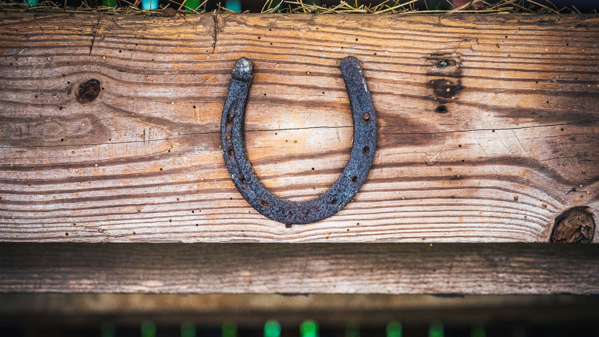 a wooden fence with a metal symbol