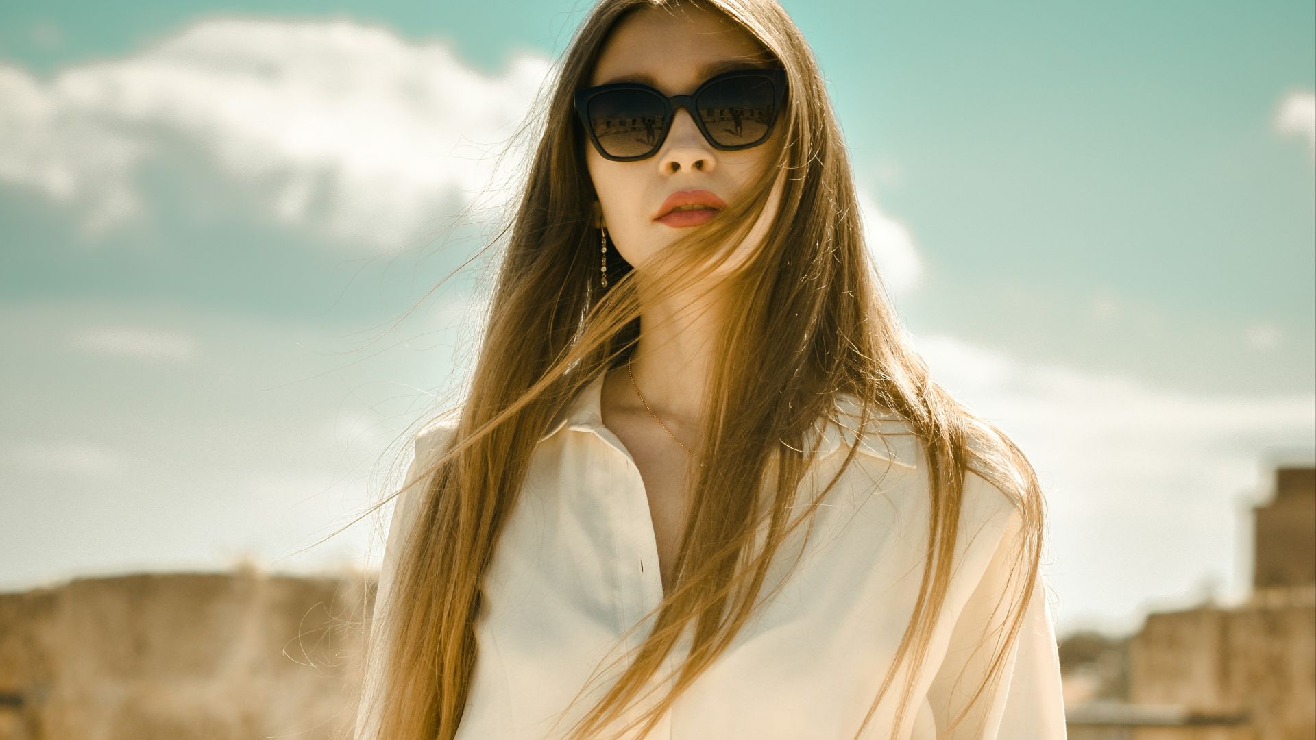 woman in white long sleeve dress wearing black sunglasses
