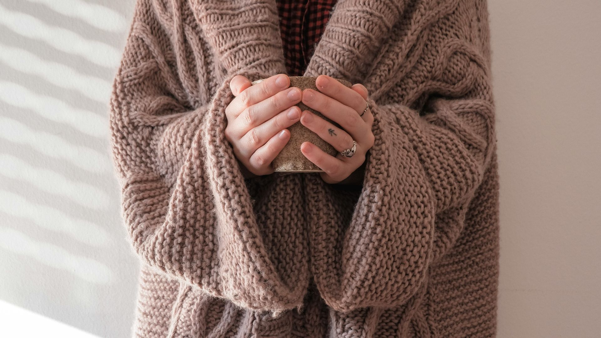 person in brown knit sweater