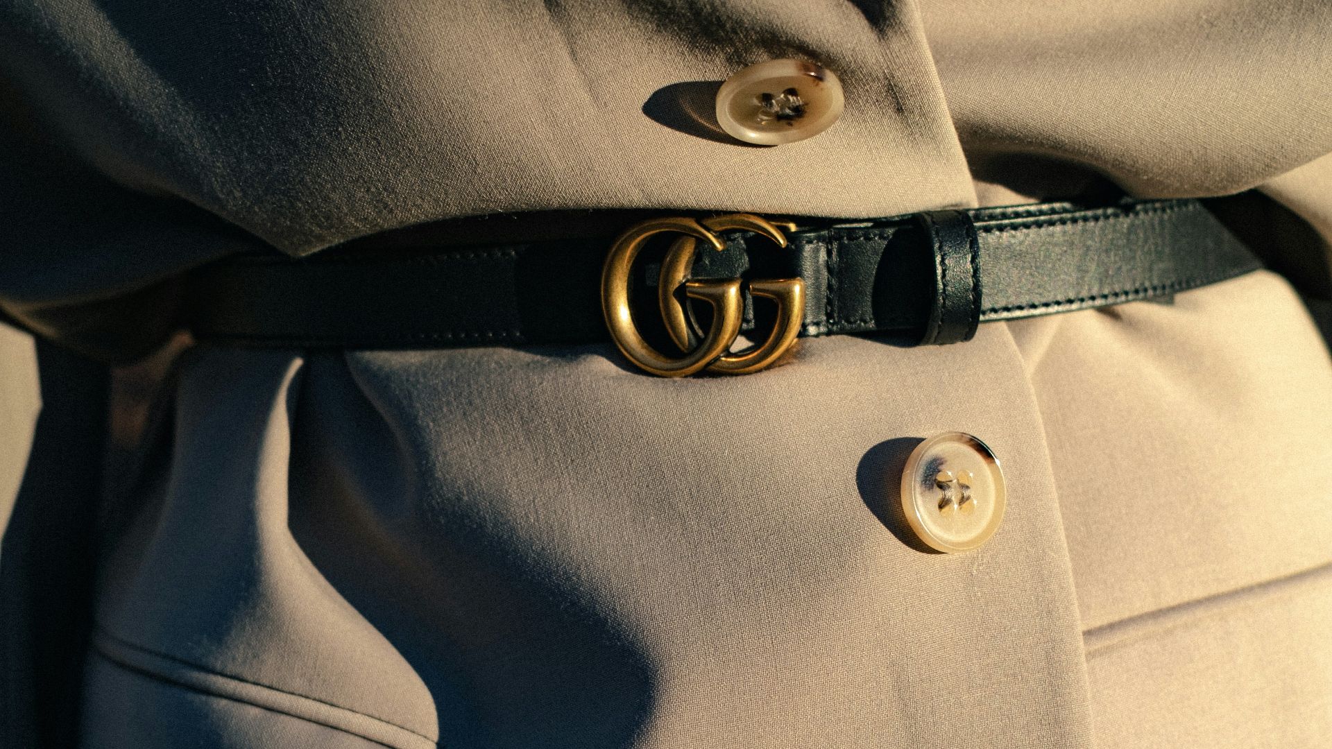 black leather belt on gray textile