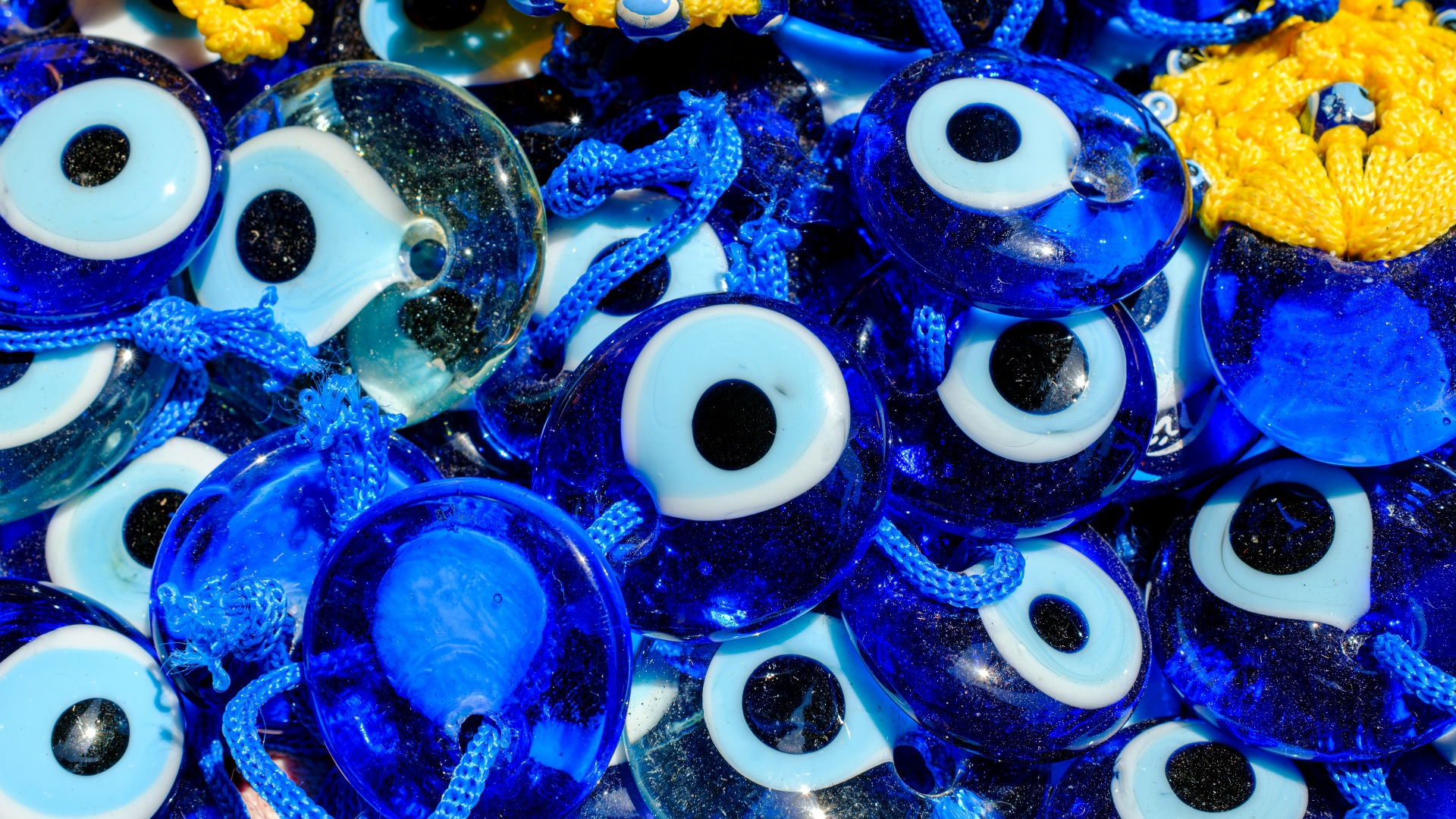 Blue evil eye charms with yellow accents