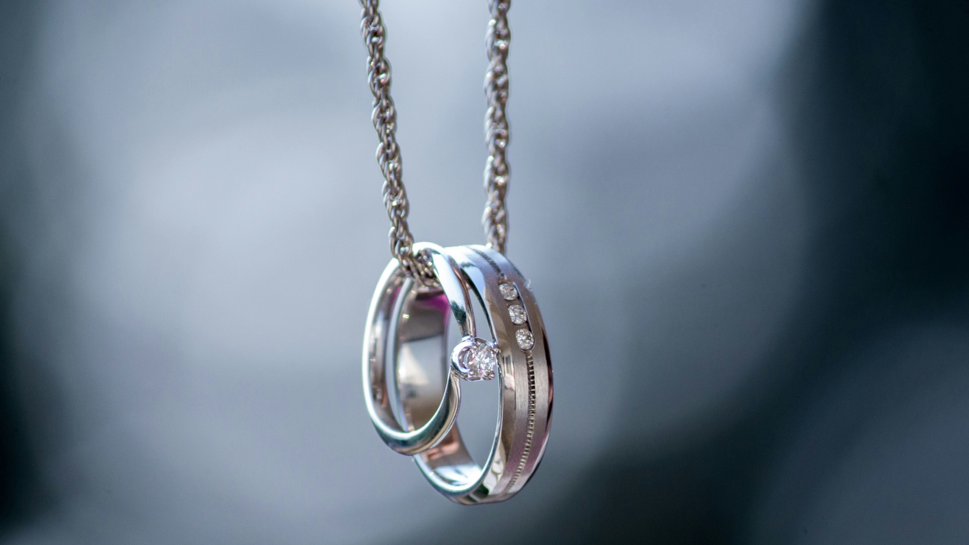 silver-colored ring pendant